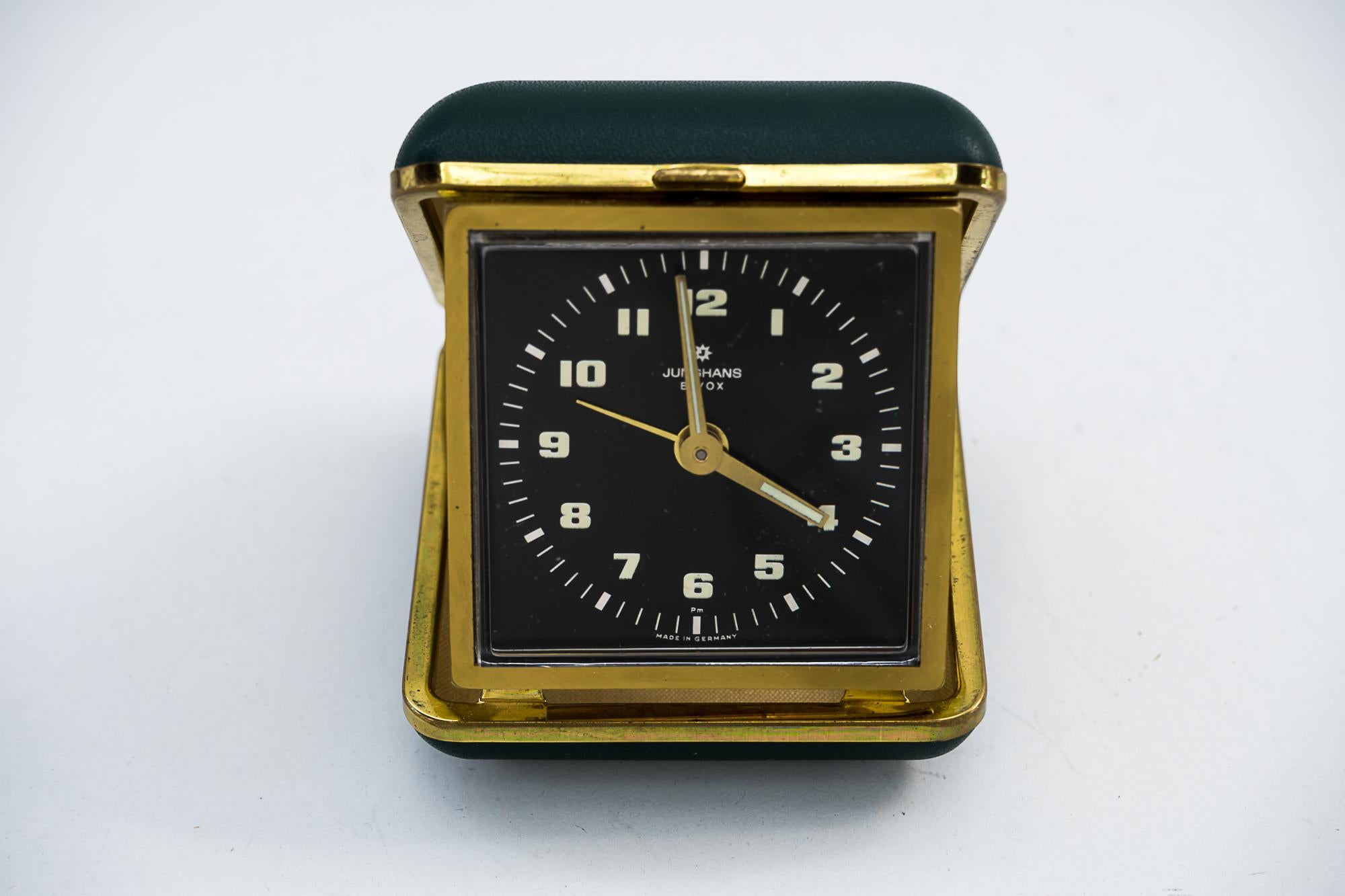 Travel alarm clock by Junghans, circa 1960s
Original condition
Brass with green faux leather cover
Still working
Measures: Open height 8cm, wide 7cm, deep 8cm
Closed height 3cm, wide 7cm, deep 8cm.