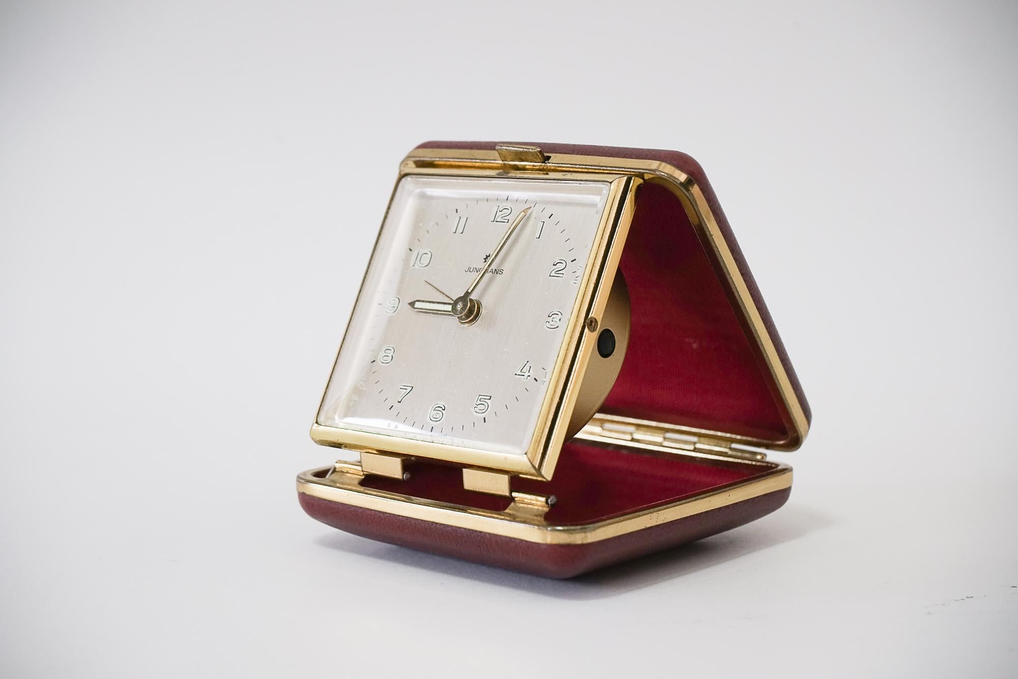 Travel alarm clock by Junghans, circa 1960s
Original condition
Brass with red faux leather cover
Still working
Measures: Open height 8cm, wide 7cm, deep 7cm
Closed height 3cm, wide 7cm, deep 7cm.