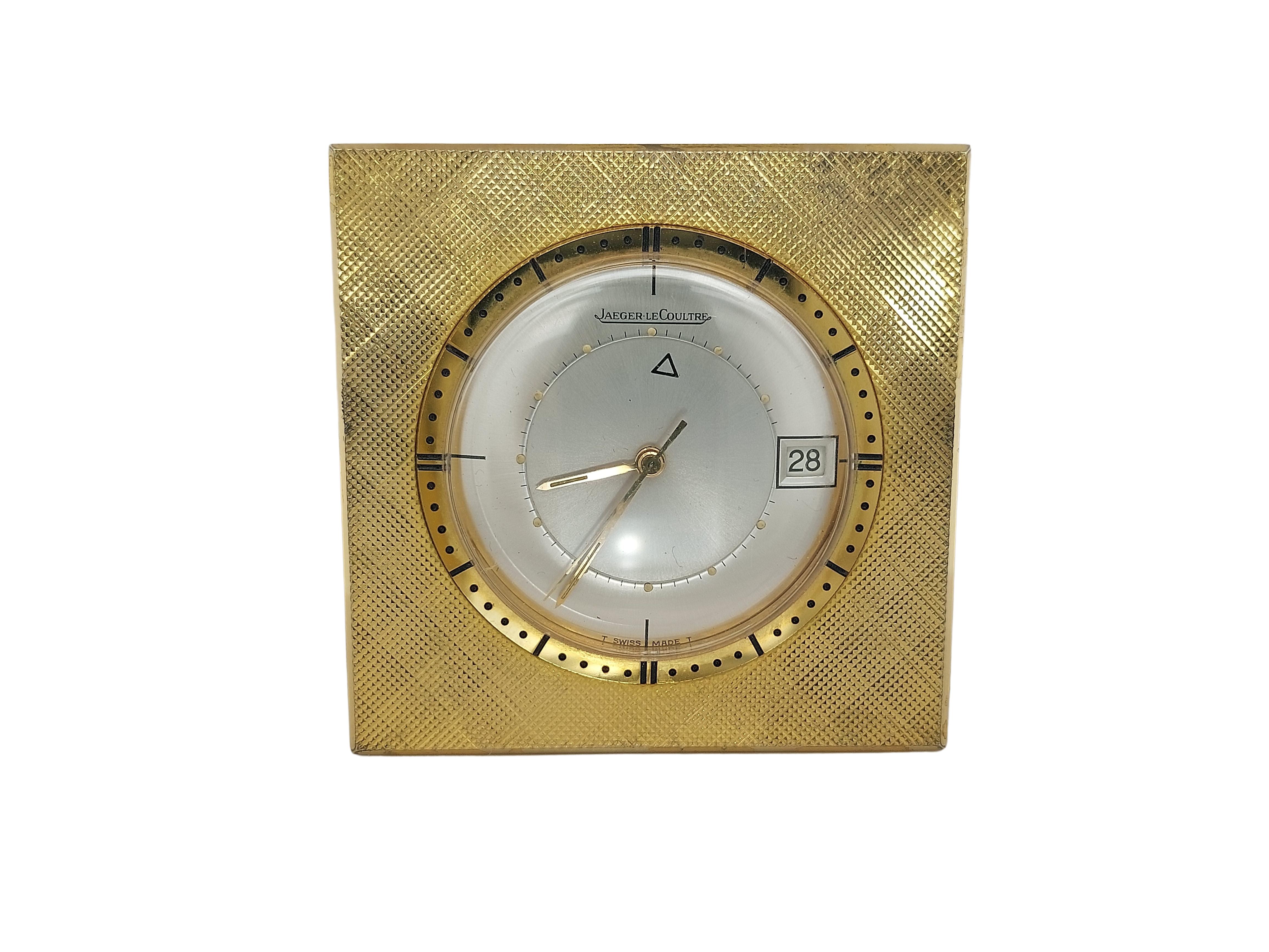 Vintage Travel Alarm Clock Made by Jaeger LeCoultre, Memovox Model, Switzerland, 

Movement: mechanical movement

Case: Gold plated case, Measurements 45 mm x 45 mm, 

Dial: Silvery dial, gold indexes, date window at 3 o'clock and bears the company