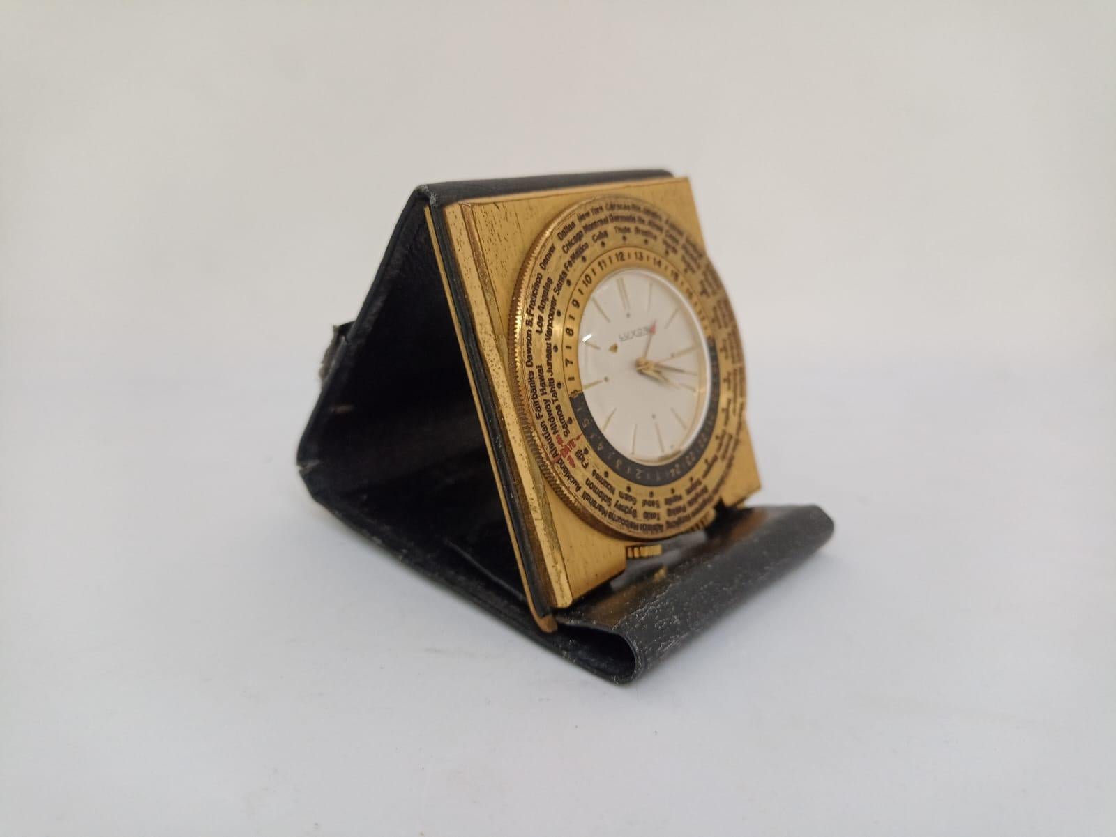 Travel clock Luxor World time
Origin Switzerland Circa 1960
Manual winding and alarm
working and in very good condition
natural wear The leather cover has a small tear.
Golden patina with natural wear
Travel clock made by the LUXOR brand to