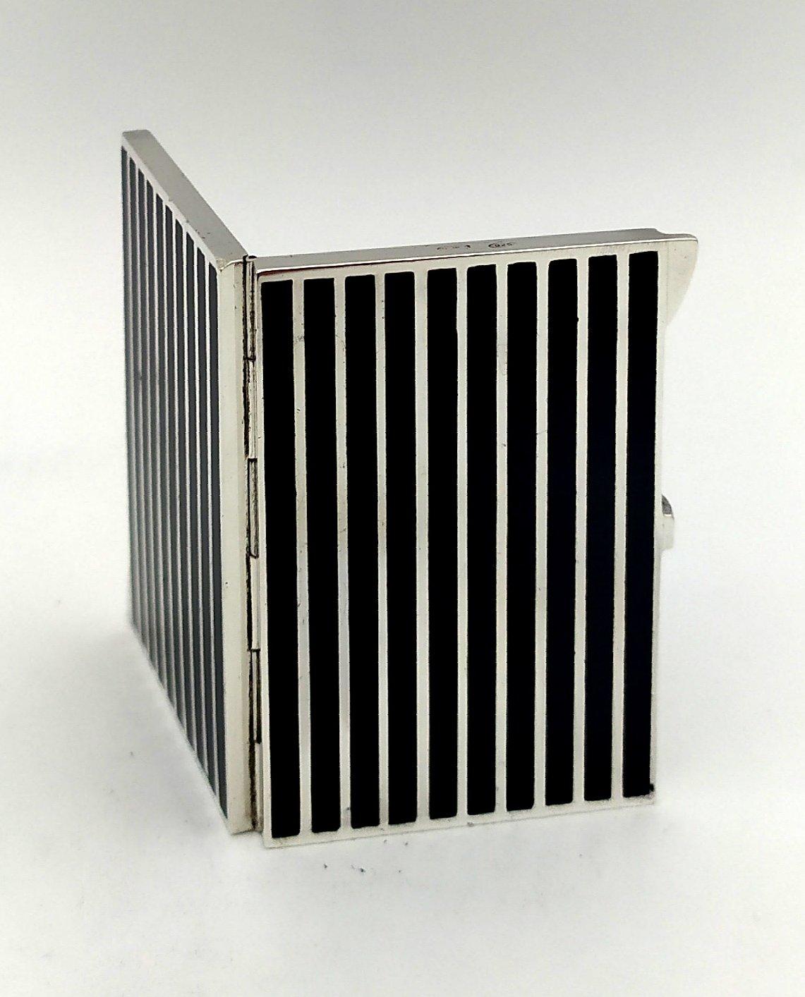 Rectangular travel photo frame with hinged booklet for 2 photos in 925/1000 sterling silver with fire-enamelled stripes in Art Deco style. Measurements cm. 4,5 x 5. Weight gr. 101. Designed by Franco Salimbeni in 1982 and produced in Florence in the
