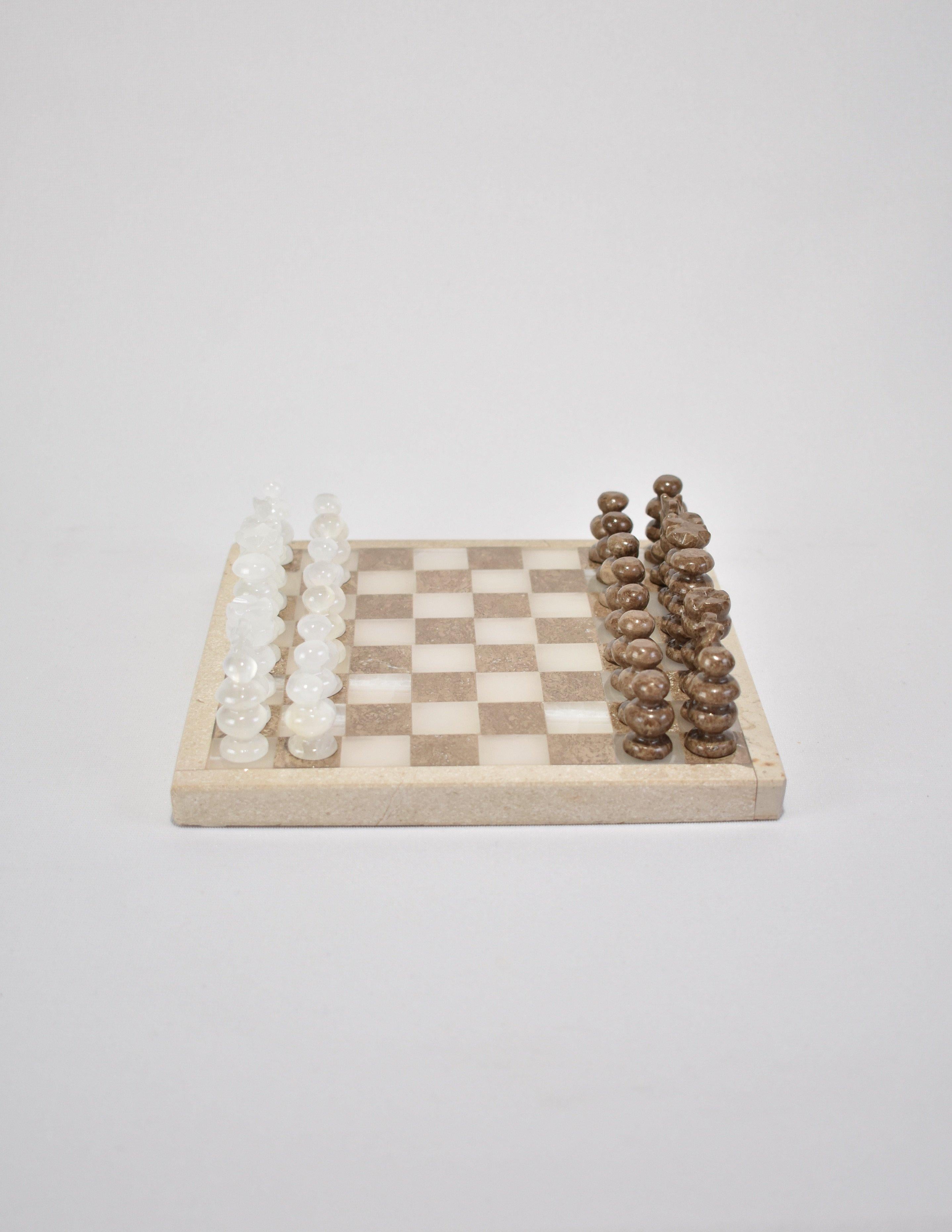 Beautiful, travel size marble and quartz chess board with hand carved pieces in brown marble and quartz. Includes 32 pieces.