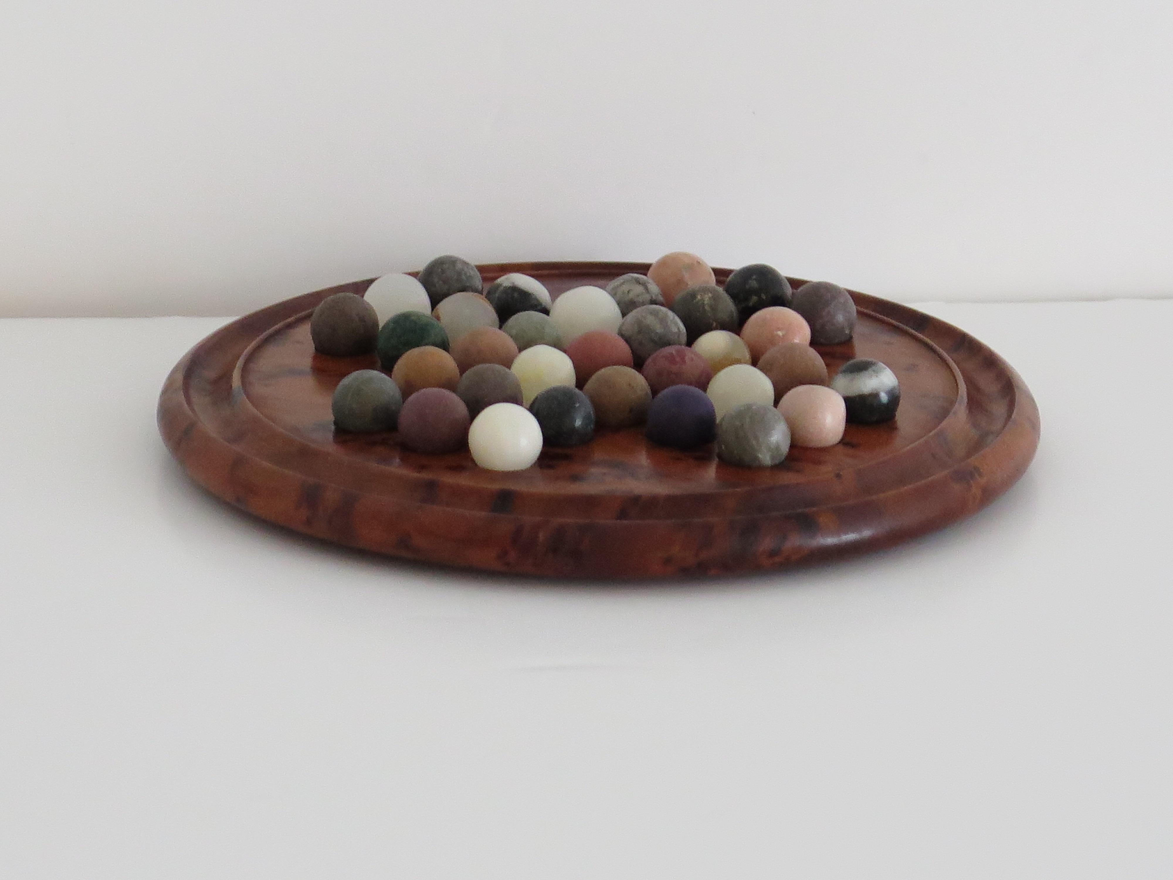 20th Century Travelling Marble Solitaire Board Game with 33 early stone Marbles, circa 1920