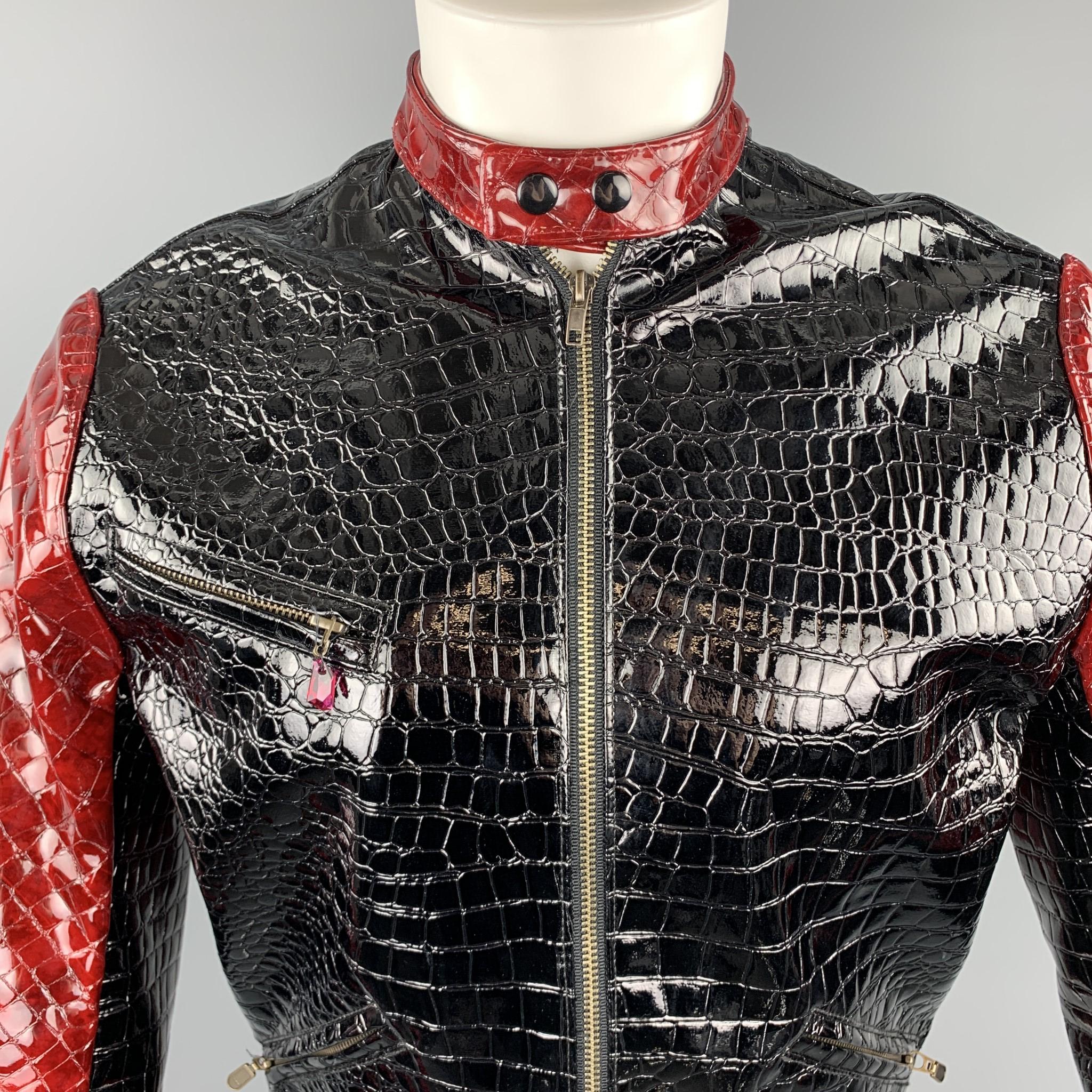 Very Rare TRAVER RAINS of HEATHERETTE biker jacket comes in black alligator textured glossy vinyl with a snap band collar, zip front, zip pockets with jewel charm, and red color block panels. Snap on collar broken. As-is. Made in Los Angeles. 

Very