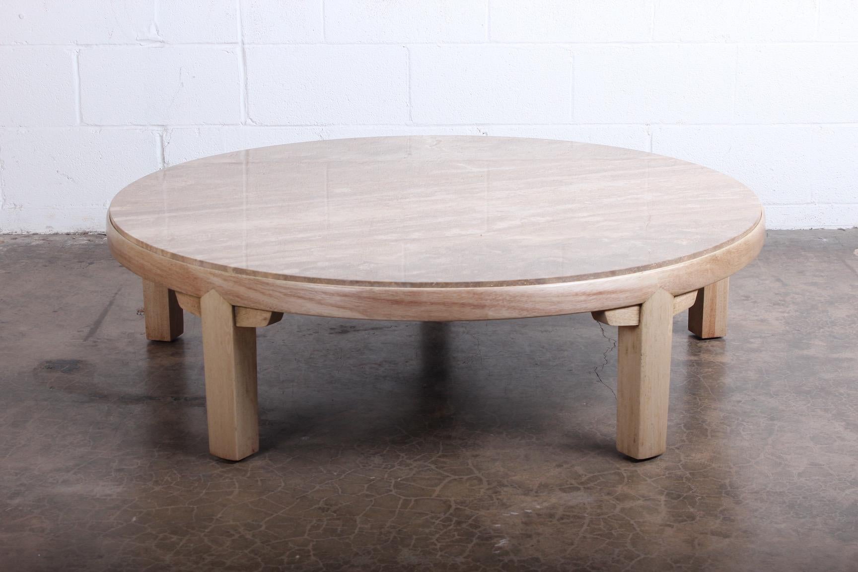 A bleached mahogany coffee table with inset travertine top. Designed by Edward Wormley for Dunbar.