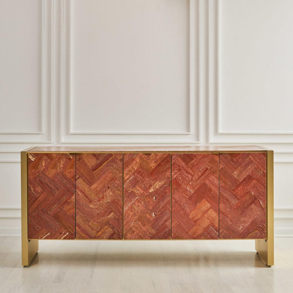 A one of a kind credenza by Ello clad in a stunning Herringbone patterned Red Persian Travertine. Hues of rust, coral and salmon pair beautifully with the signature Ello brass frame and hardwire. Each door opens to reveal shelving and a clean