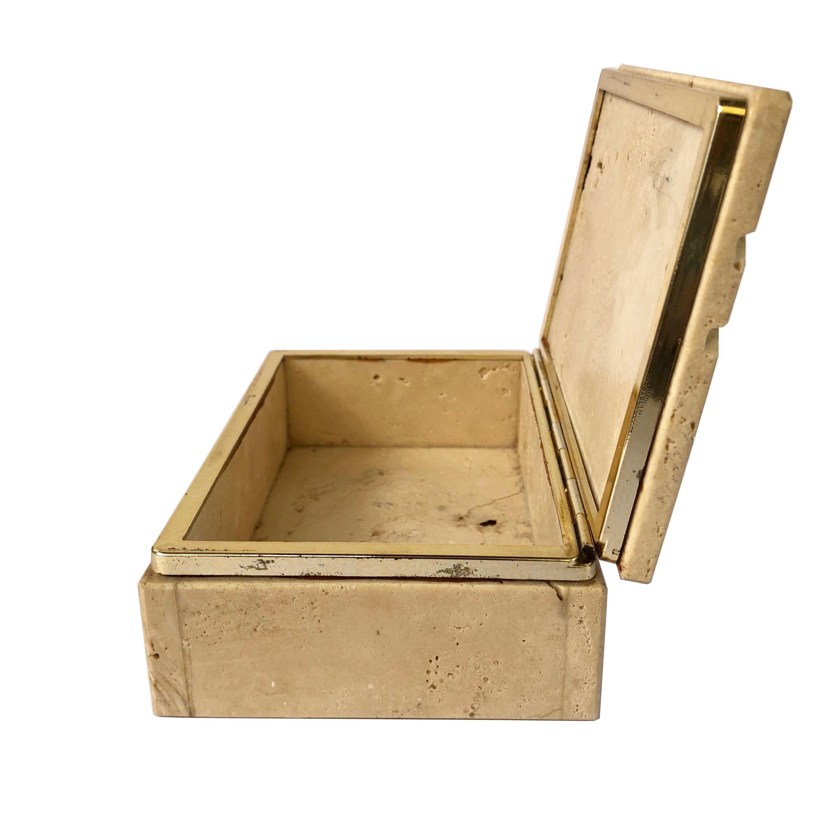 This vintage organic modern Italian hinged box is made of travertine stone and brass. It is from the 1970s and it was made by the Fratelli Mannelli.
The travertine has natural craters in it and on the front it looks like it had been chipped but