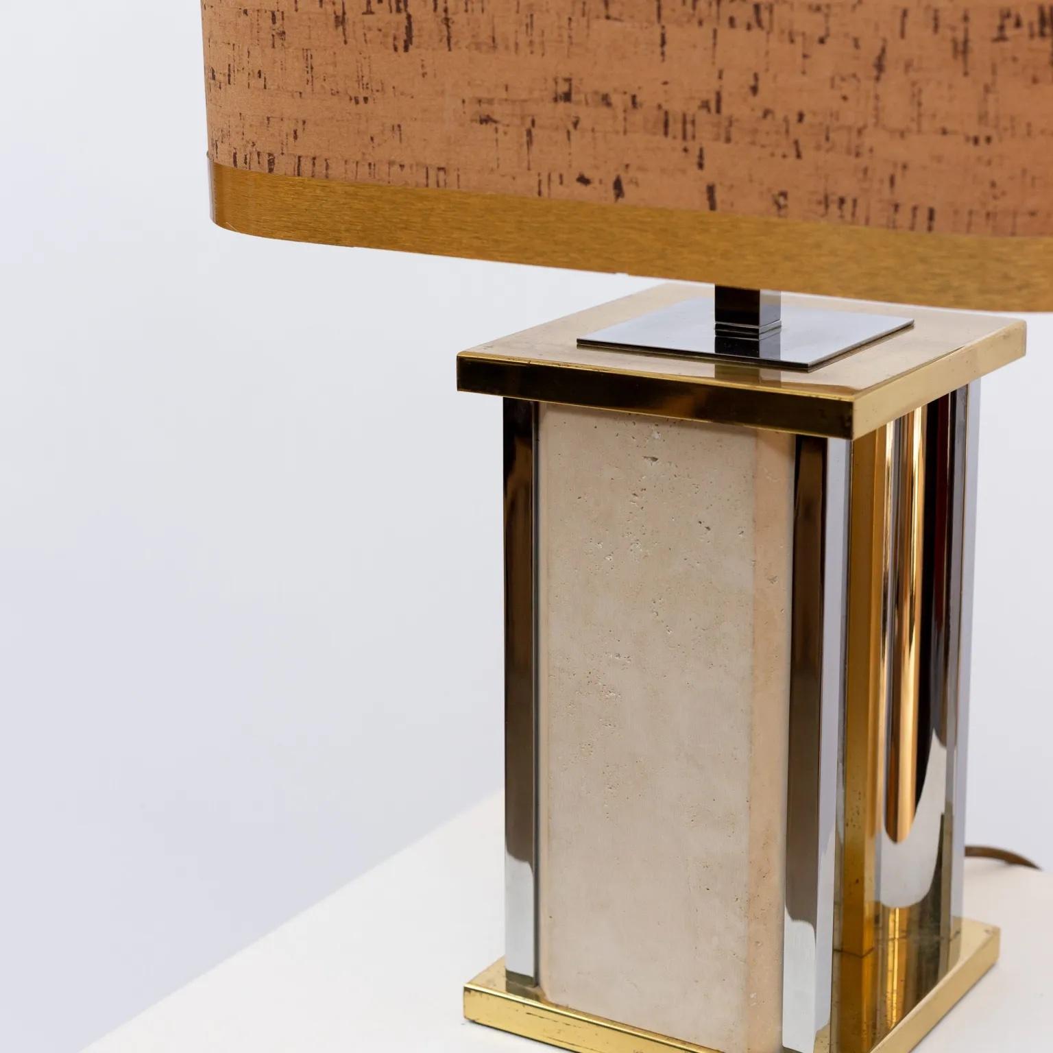 A large travertine marble and brass table lamp by Gaetano Sciolari. Retains the original rectangular cork hood shade. Signed on bottom of base.
Base dimensions (incl. lamp holder): 17x17x37 cm.