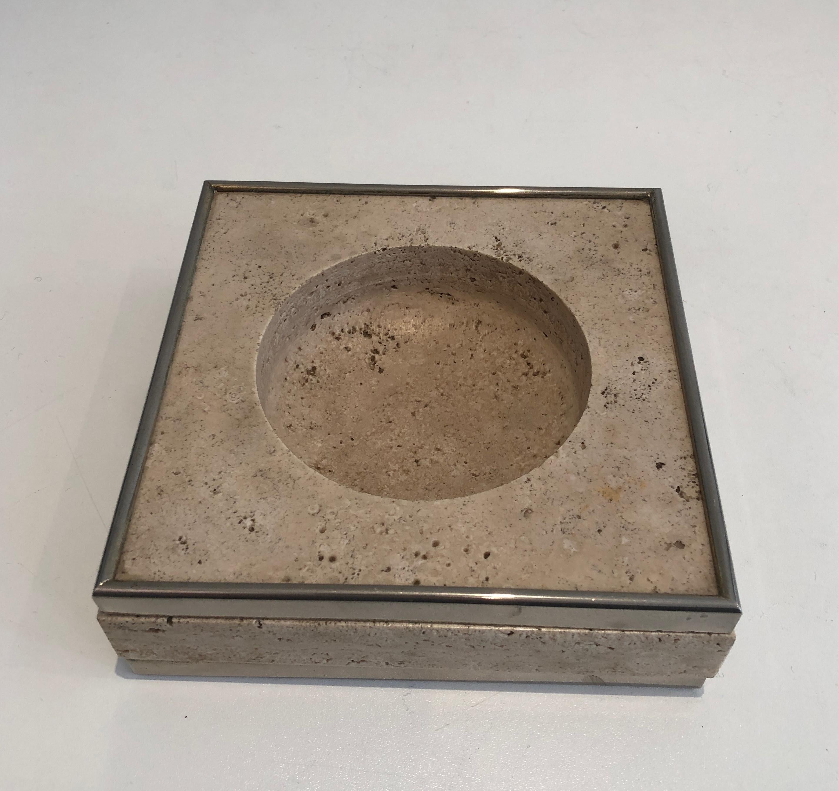 This vide-poche is made of travertine and chrome. This is a French work. Circa 1970