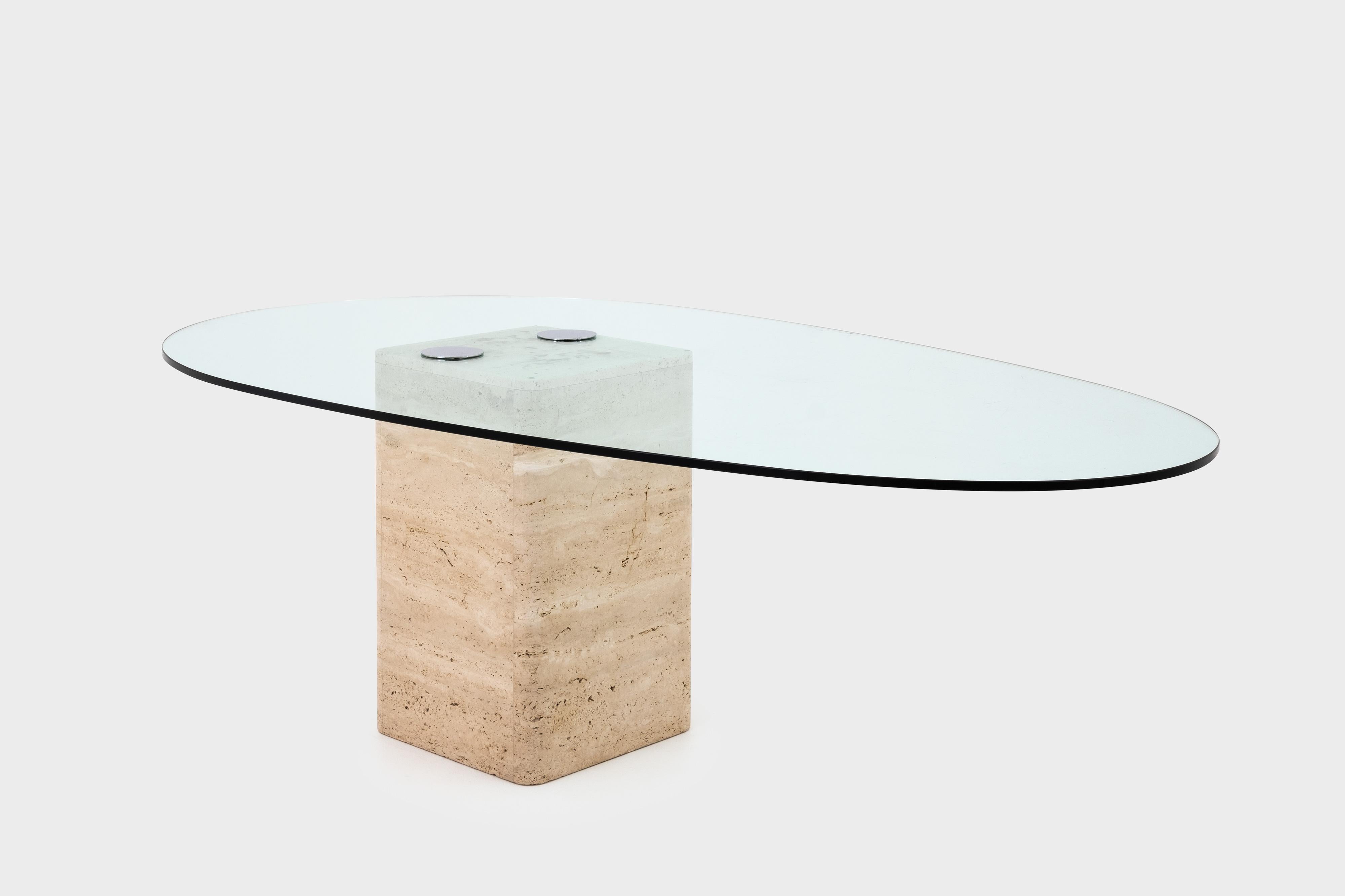 Stunning dining table by Sergio and Giorgio Saporiti, Italy, circa 1970. The table has a heavy cubic base made of travertine with a 1.5 cm egg-shaped glass top. The hardened glass top is fixed to the base with two chrome disks which are screwed into