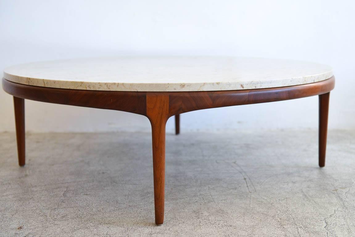 Round travertine and sculpted walnut coffee table, circa 1965. Gorgeous creamy Italian travertine in very good condition with sculpted walnut base. Classic and timeless design, reminiscent of Bertha Schaefer or Gio Ponti designs. 


Measures: 42