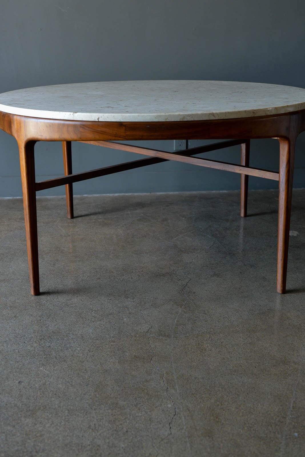 Travertine and sculpted walnut dining or bistro table, ca. 1965. Beautiful sculpted walnut with original Italian travertine top and desirable X base walnut stretchers. Very good original condition with no chips or cracking. Walnut is also original