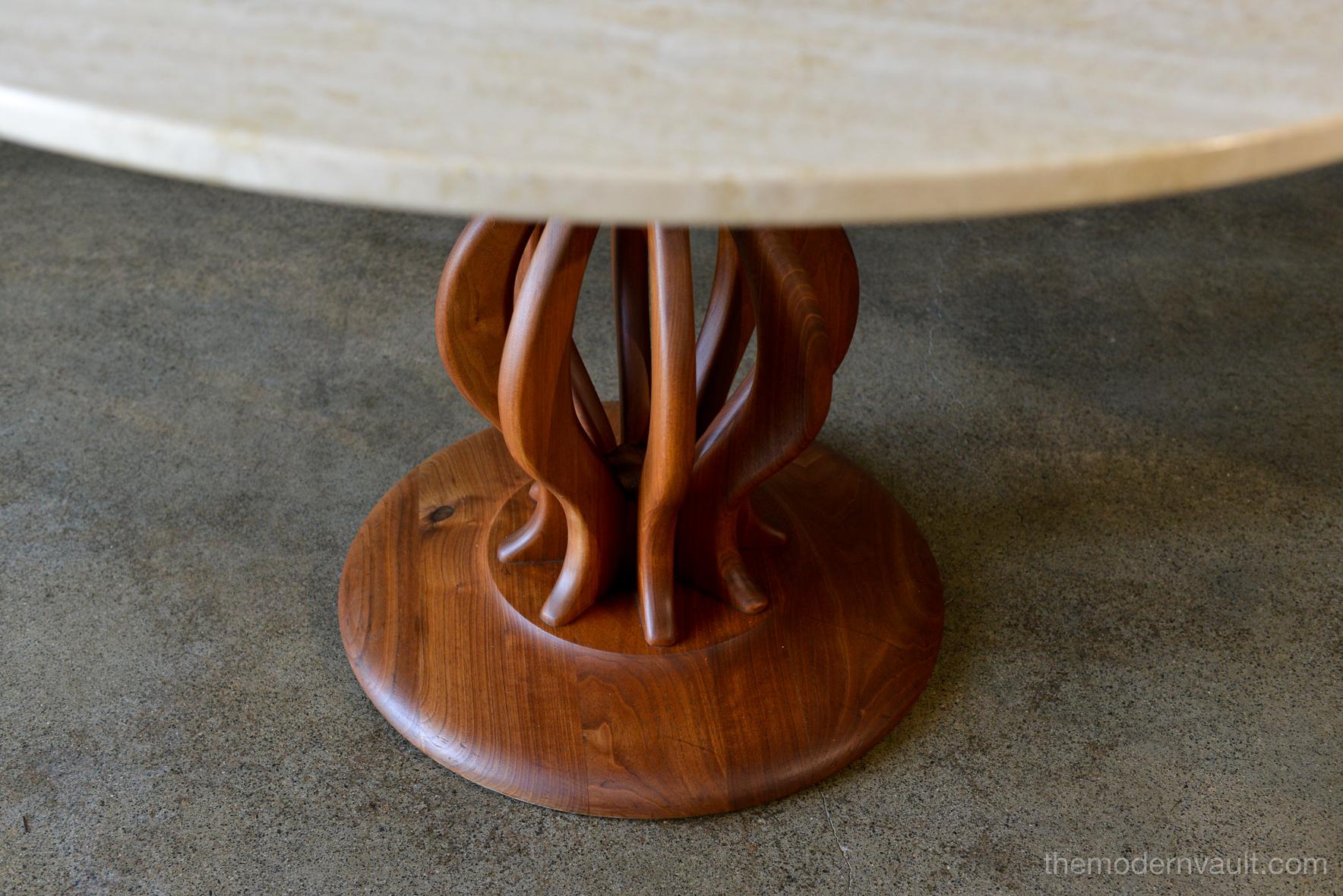 Travertine and sculpted walnut dining or bistro table, circa 1970. Beautiful sculpted walnut pedestal base with Italian travertine top in perfect condition. Absolutely no chips or cracks and walnut has beautiful color and grain. Could be used as a