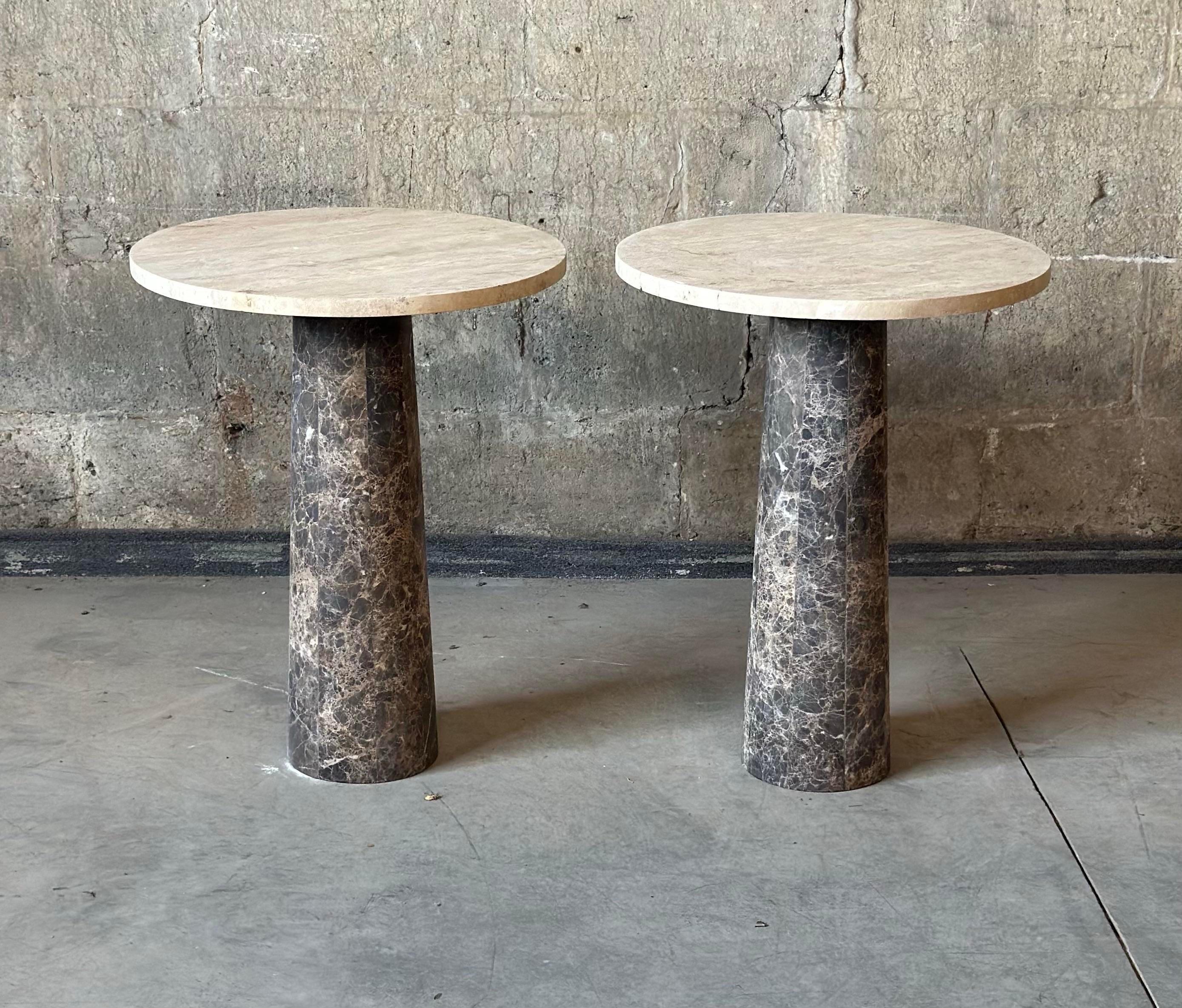 A stunning pair of travertine and tessellated marble accent tables. Thick round table tops and tapered angled bases, perfect for adding contemporary charm to your indoor or outdoor space.