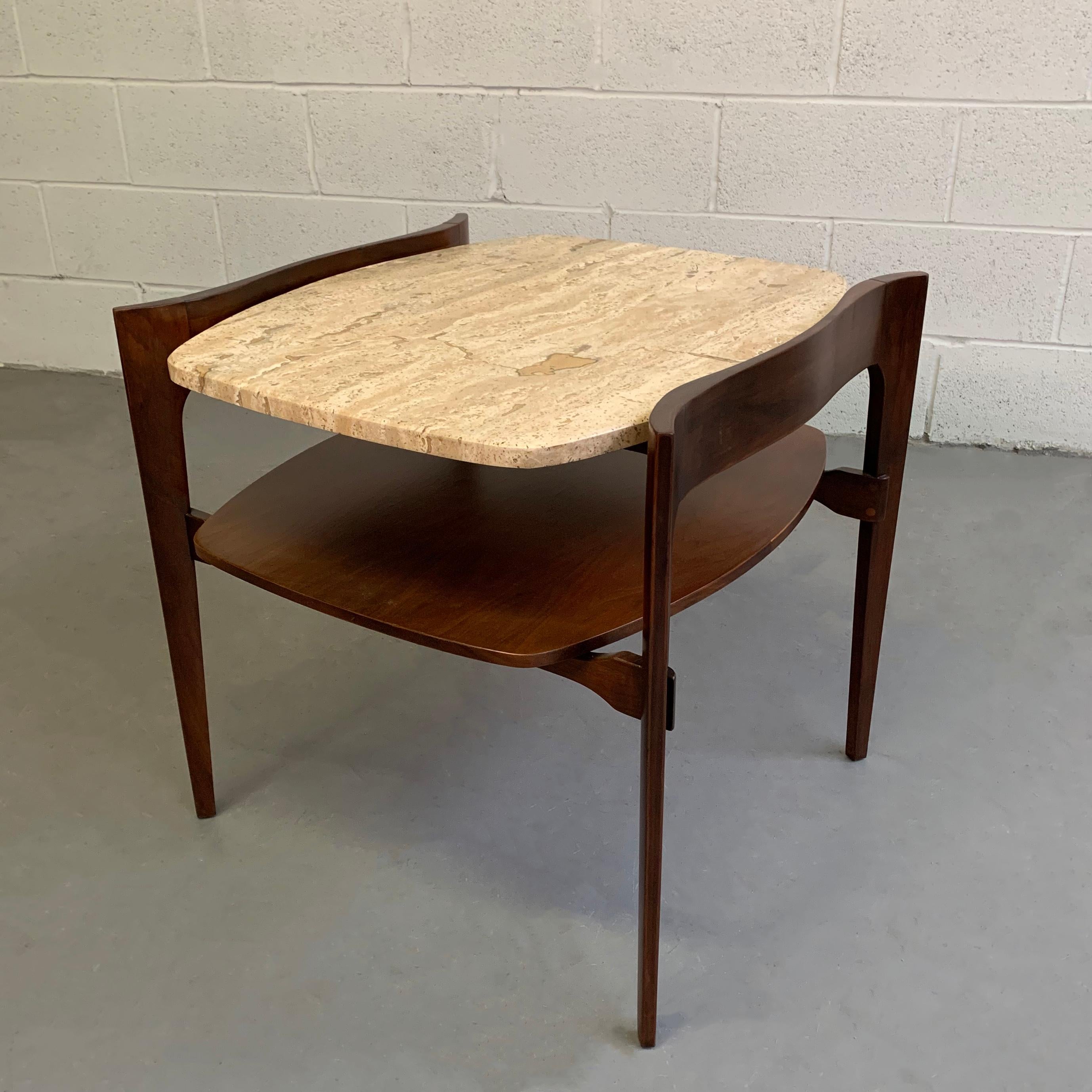 Beautifully detailed side or end table by Bertha Schaefer for M Singer & Sons features a sculptural walnut frame with Italian travertine top. The lower level is 15 inches height and the space between is 6 inches.