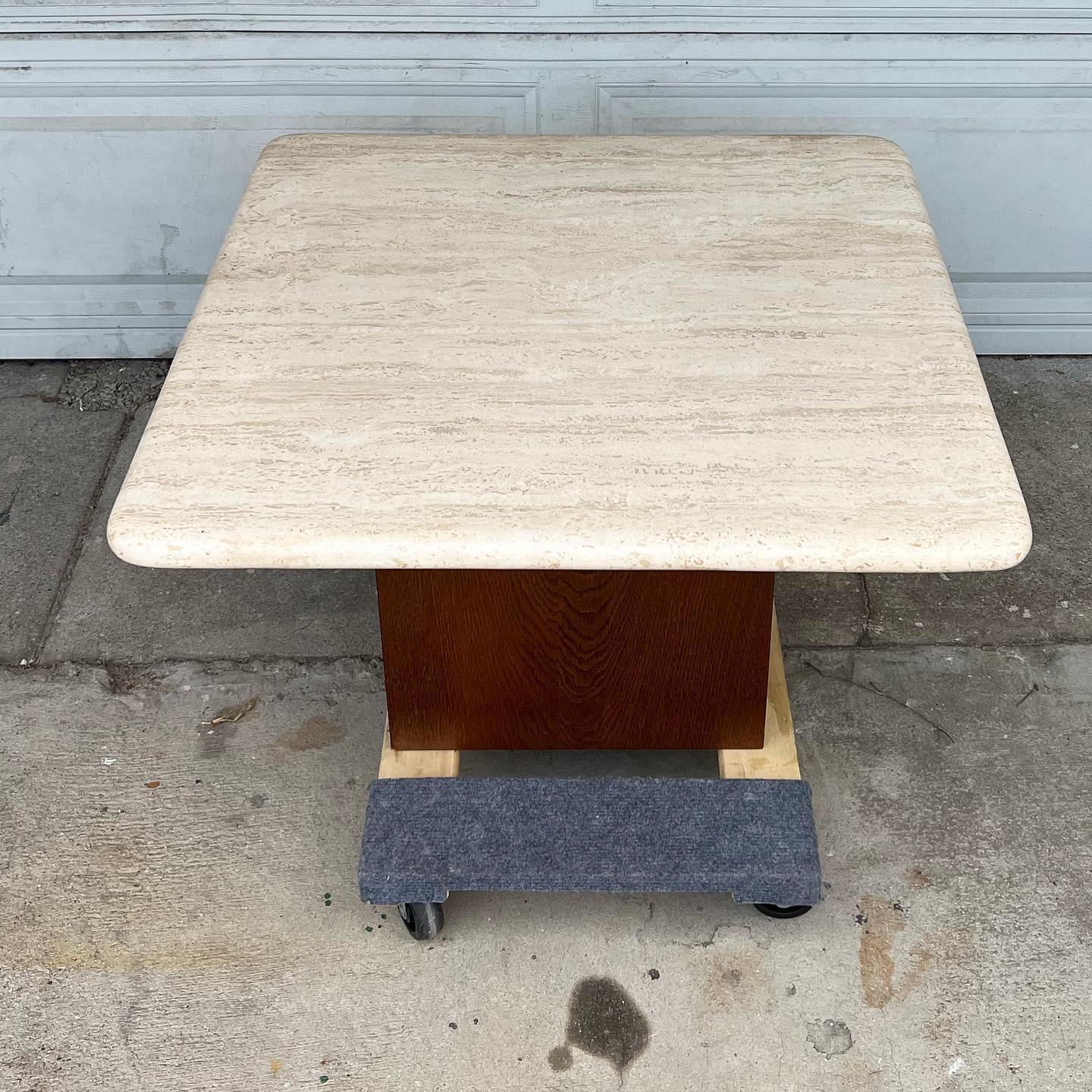 Petite coffee table with perfect travertine top atop a hollow walnut stained wooden cube base. Excellent condition. c late 1980s early 1990s. Base appears more cherry in photos but is closer to a walnut- see close up  for  accurate coloring

the