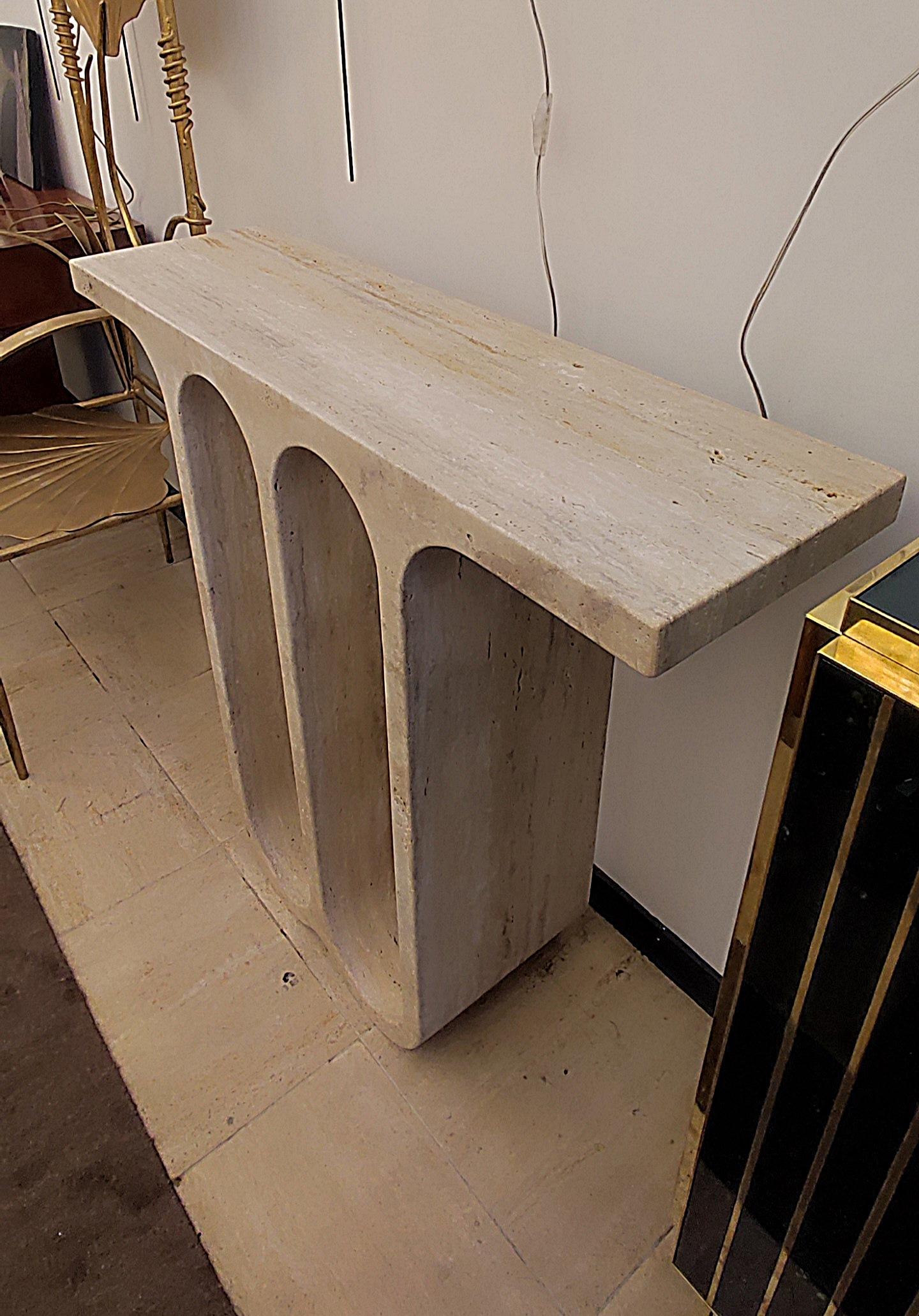 Exceptional quality for this console carved from one piece in a large block of travertine..