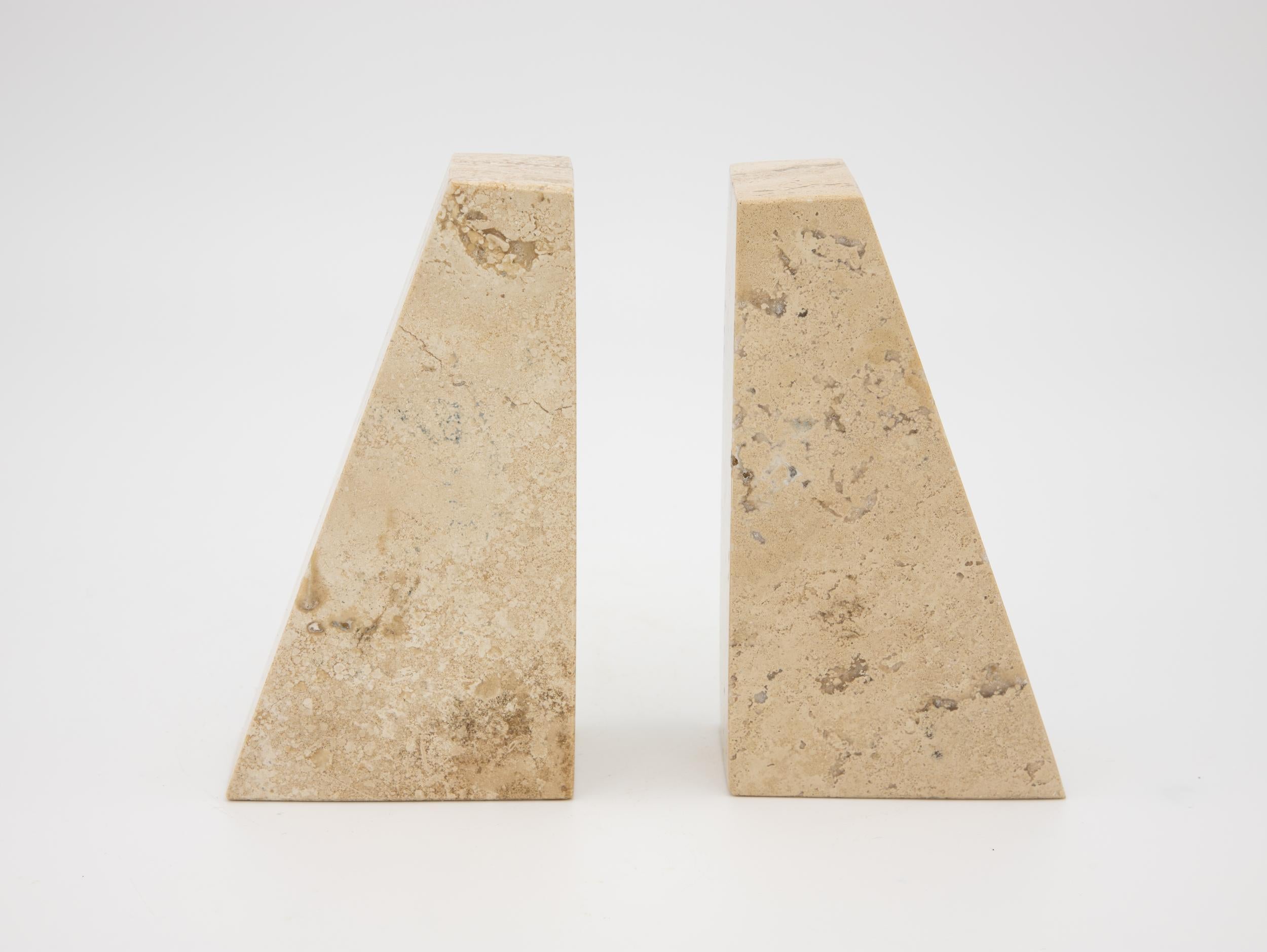 These polished travertine bookends are heavy and carved in the 1970s postmodern look. There a few natural imperfections consistent with this type of stone. The age of these bookends is unknown.