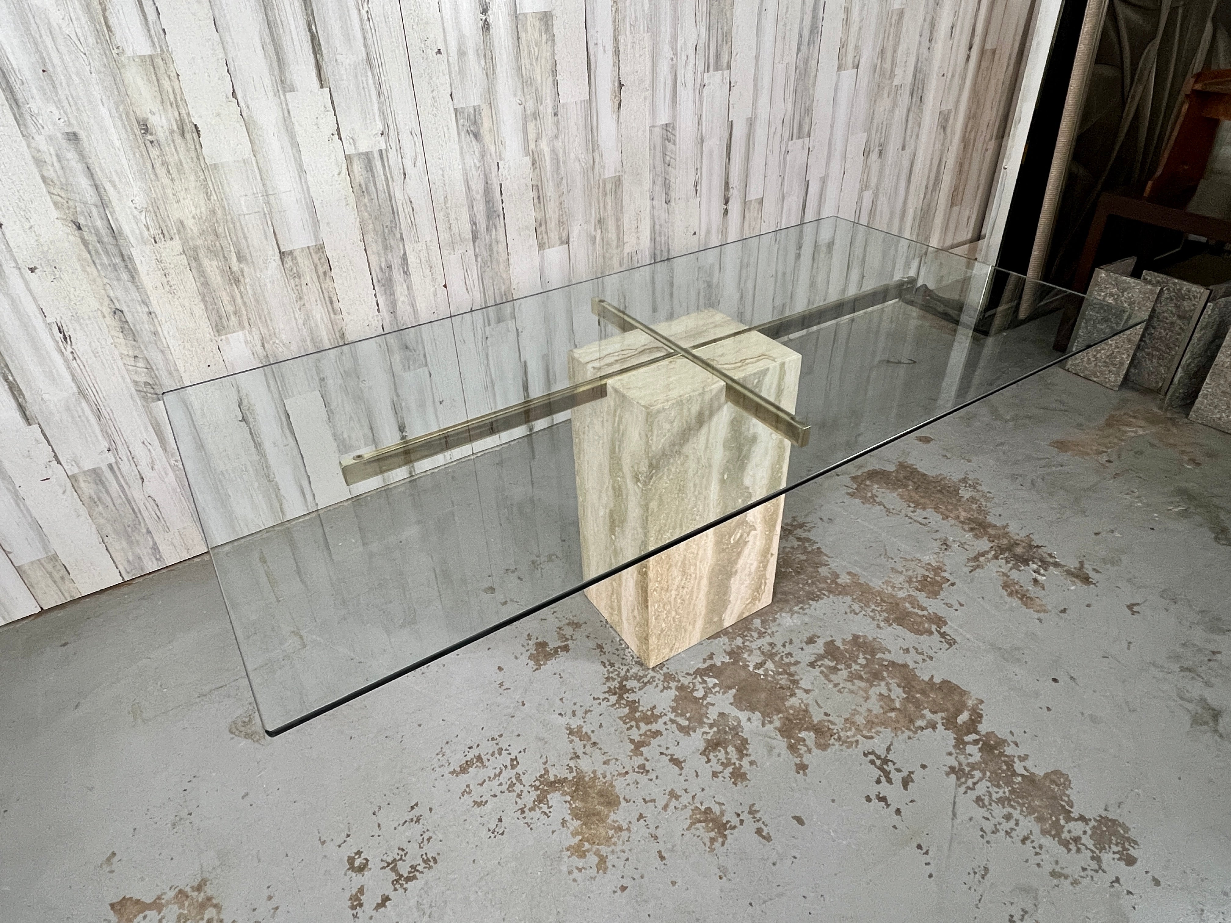 Travertine base with brass cross design that supports the glass top. Made in Italy.