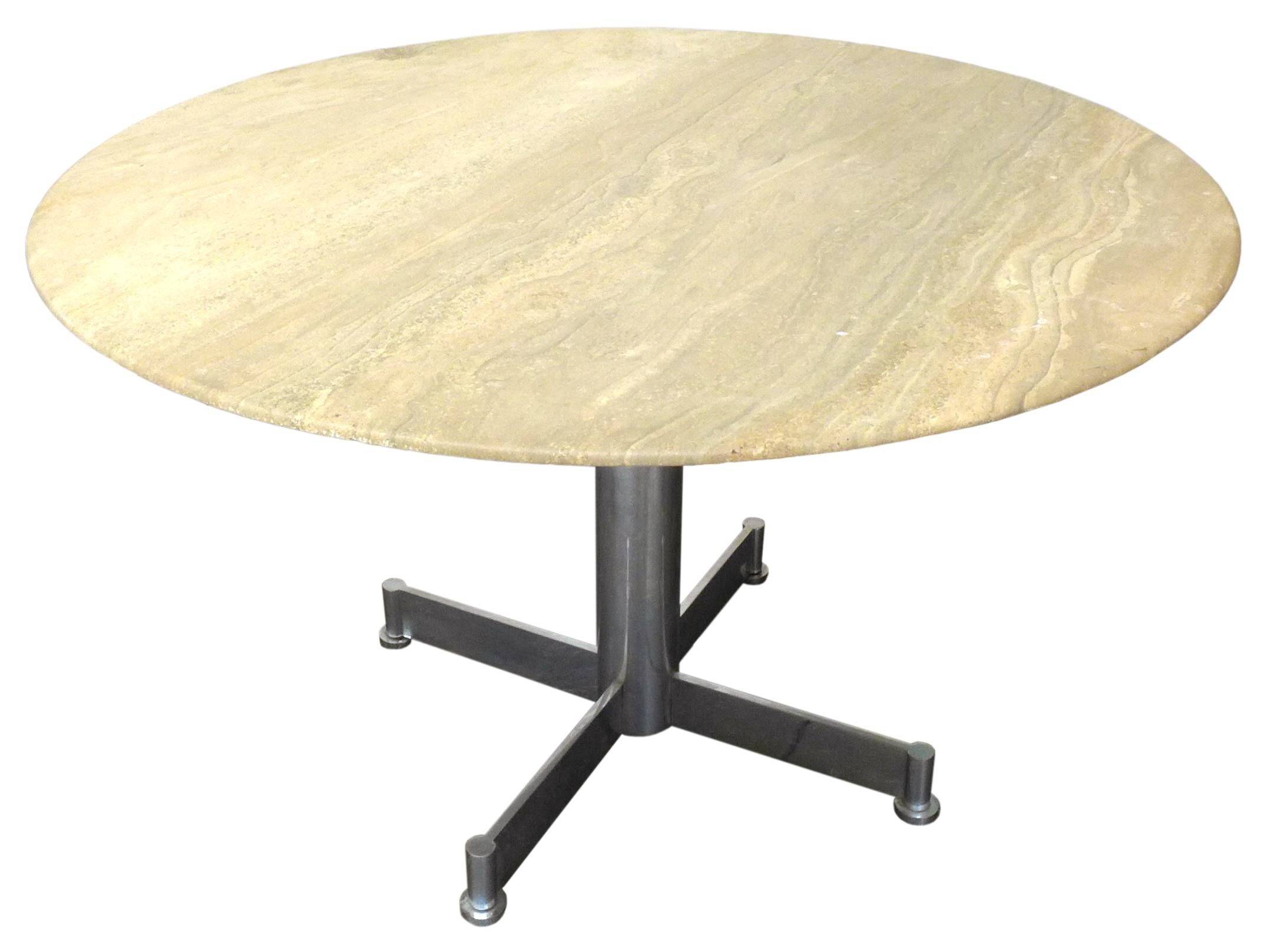 A handsome, round dining table in travertine and chromed steel.
Pedestal base features machined, adjustable pod feet. Table top in a classic travertine oatmeal hue wearing wonderful grain and a subtle underside bevel. Great scale and mix of