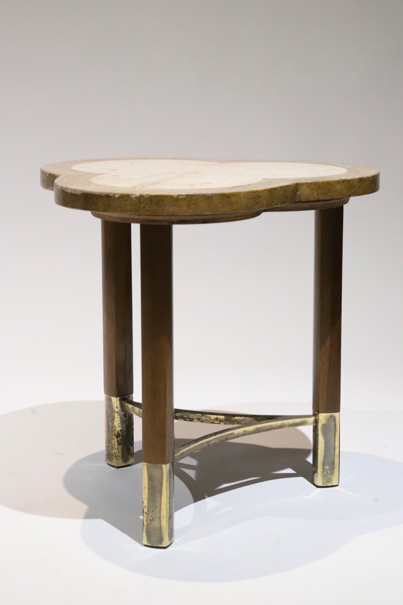 Clover leaf shaped side table with two tone travertine top, wood legs and brass caped feet. Pictured with Paul Mccobb armchair and Iphone for scale.