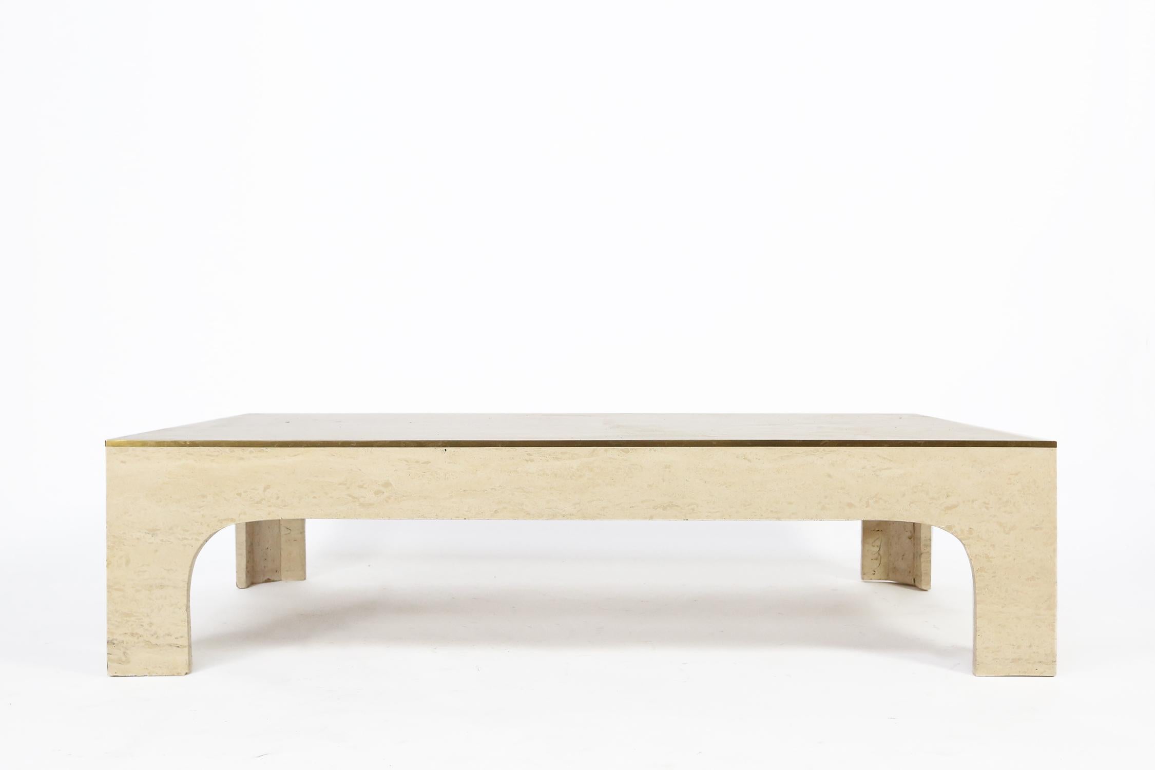 A stylish coffee table designer by Italian designer Willy Rizzo. Produced in Italy circa 1960, this coffee table combines timeless travertine and brass details, in a refined and casual composition. 
The table stands in an excellent condition.