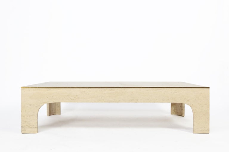 A stylish coffee table designer by Italian designer Willy Rizzo. Produced in Italy circa 1960, this coffee table combines timeless travertine and brass details, in a refined and casual composition. 
The table stands in an excellent condition.