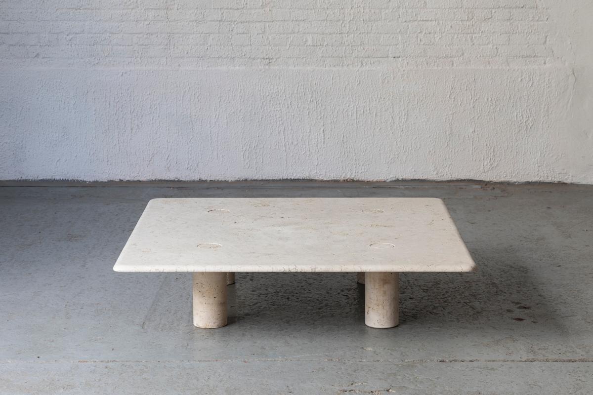 Travertine c¬offee table designed by Angelo Mangiarotti and produced in Italy by Up&Up around 1970. The solid travertine top rests on 4 travertine, column shaped feet. A great combination of square and round shapes. The feet can be taken off for