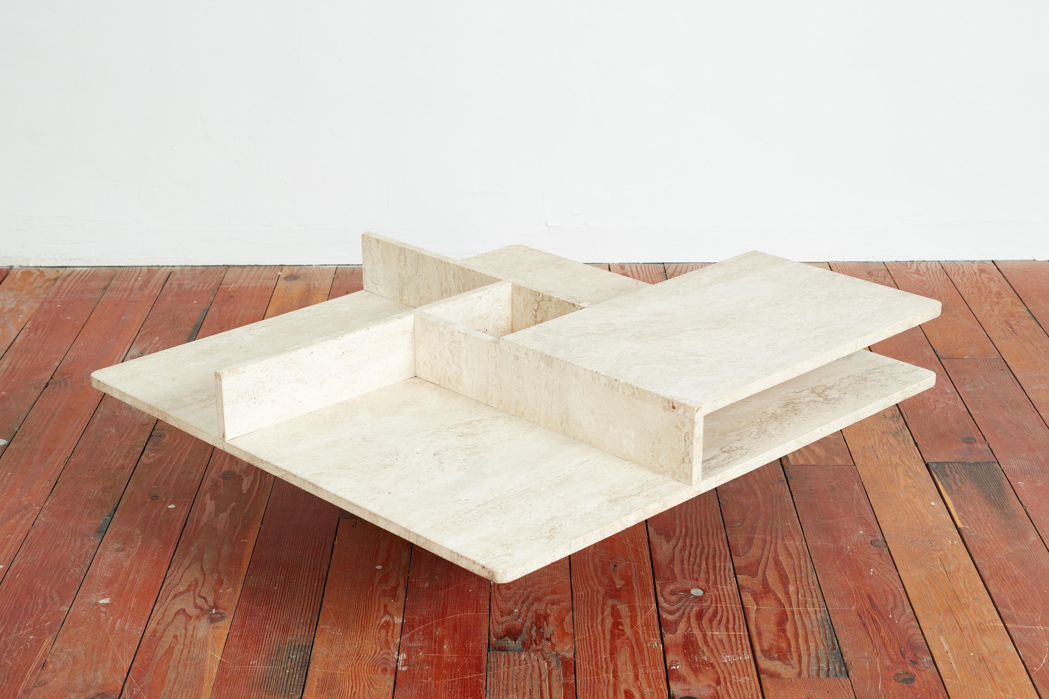 Beige travertine coffee table in angular geometric shape with floating compartments Fantastic design.