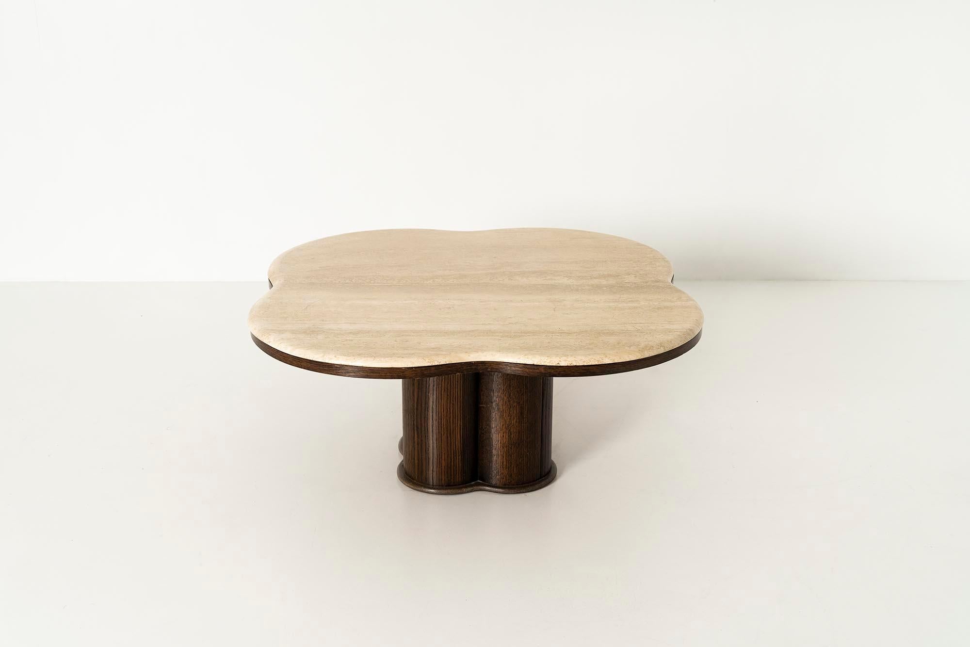 Stunning Coffee Table in the Style of Jean Royère Style from the 1970s. This table features a wooden base and a travertine top. The table has the shape of a clover. The wooden base features nice details with an edge completely at the bottom. We love