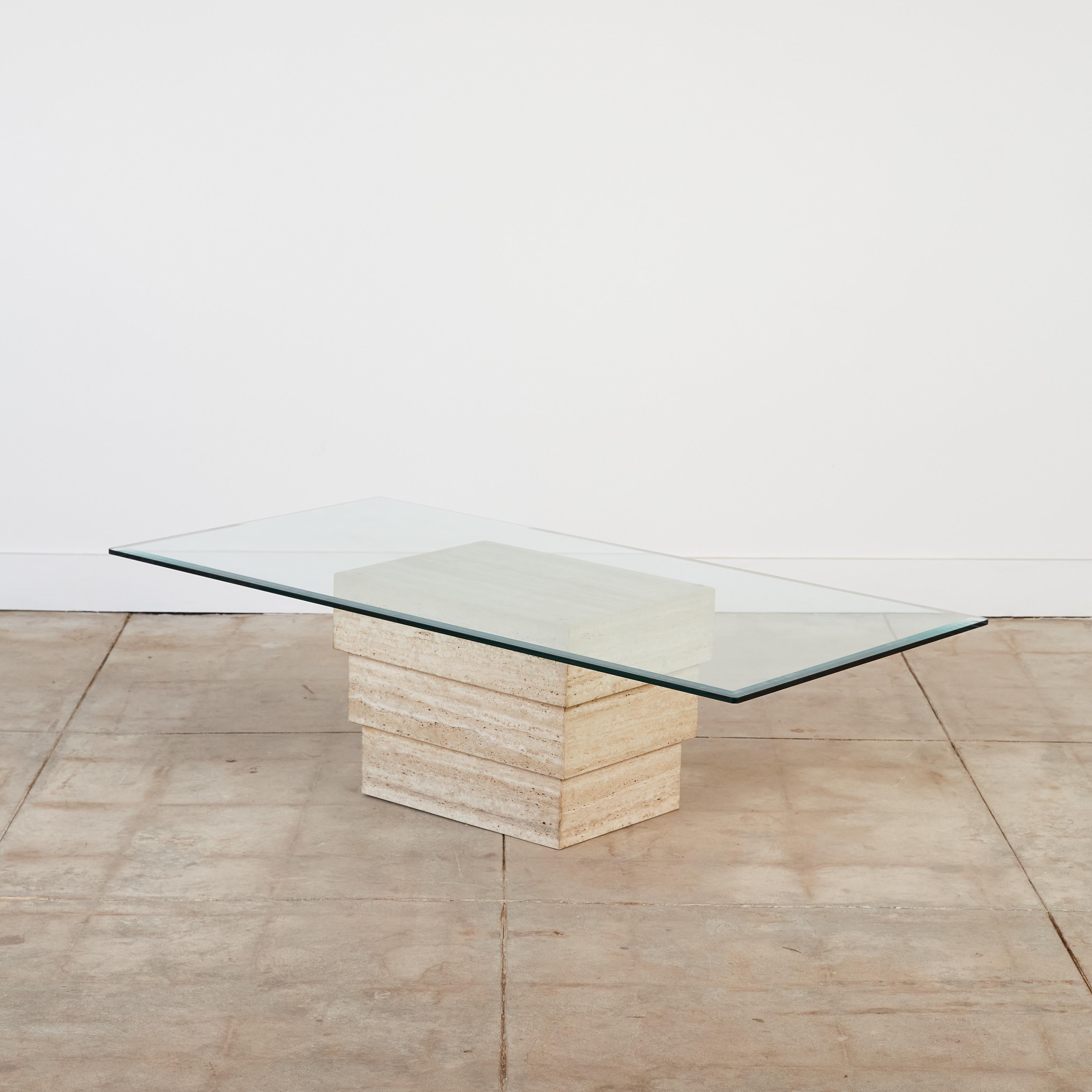 Coffee table with travertine base and glass top. This table features an ascending stacked tri-level travertine base with a rectangular bevel edged glass top. Can be used as a side table without the glass top.

Dimensions: 60” width x 30” depth x