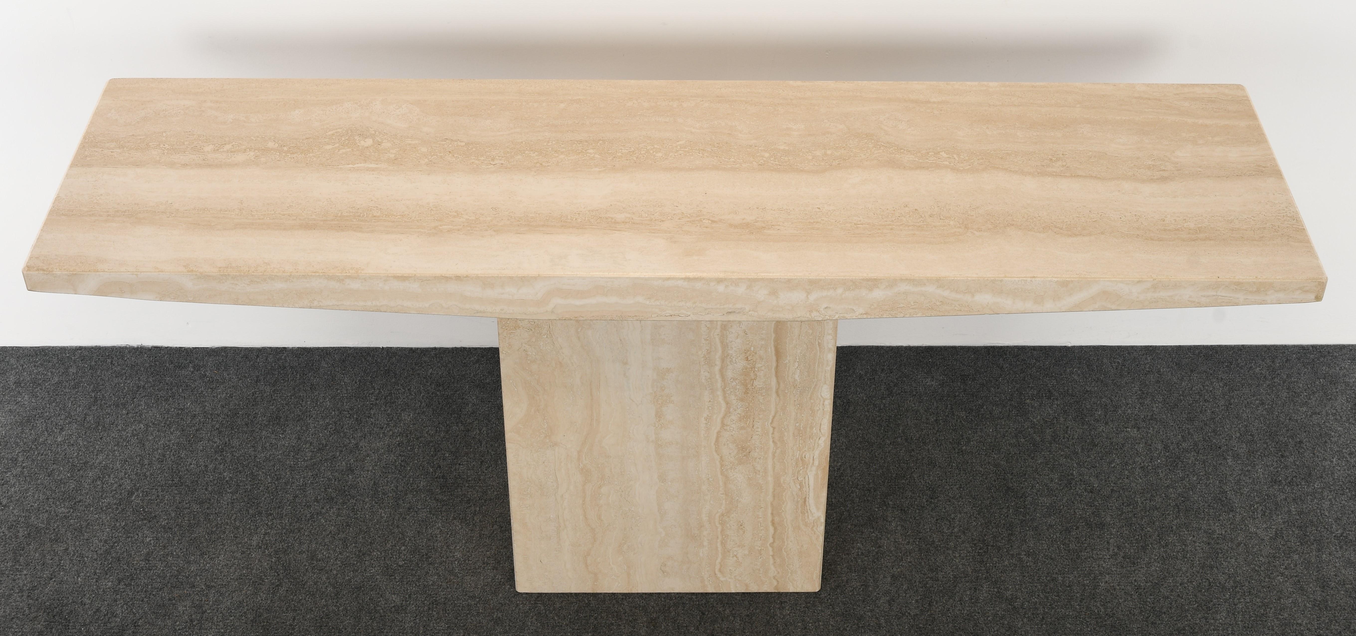 A Minimalist travertine console table for Stone International. This table is structurally sound and has no damage. This console can be displayed in the center of a room. 

Dimensions: 29.38