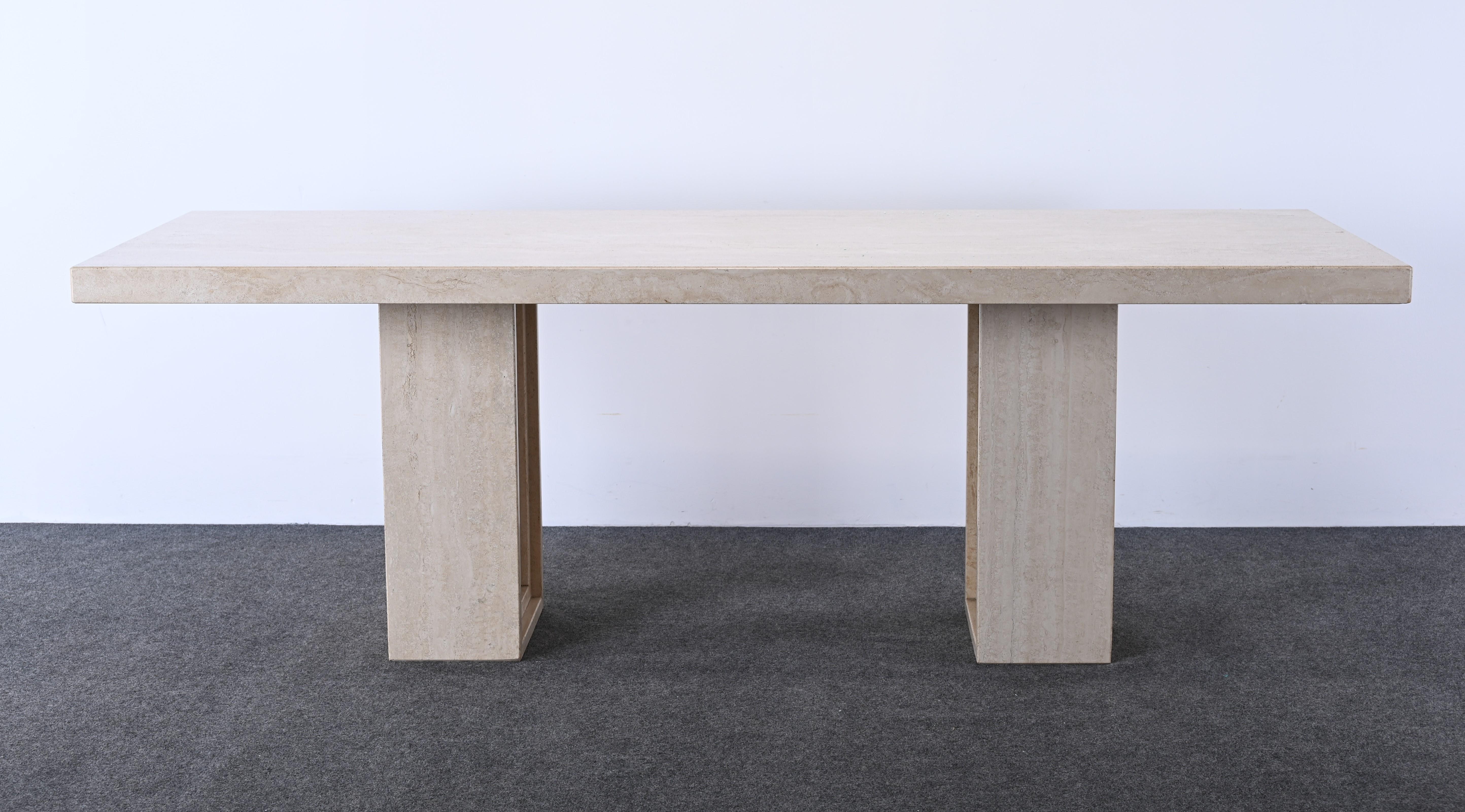 A chic modernist Travertine dining room table by Ello Furniture. It could also work as an architectural desk or designer work table. This table would look stunning in any interior such as a beach house, modern or traditional home. The base comes in