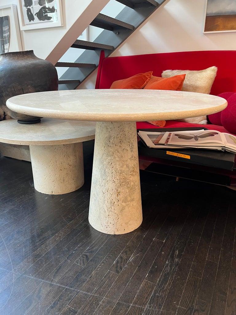 White Roman travertine table by Le Lampade. 
Round travertine top supported by a travertine tapered shaped base. These tables can be custom made.
