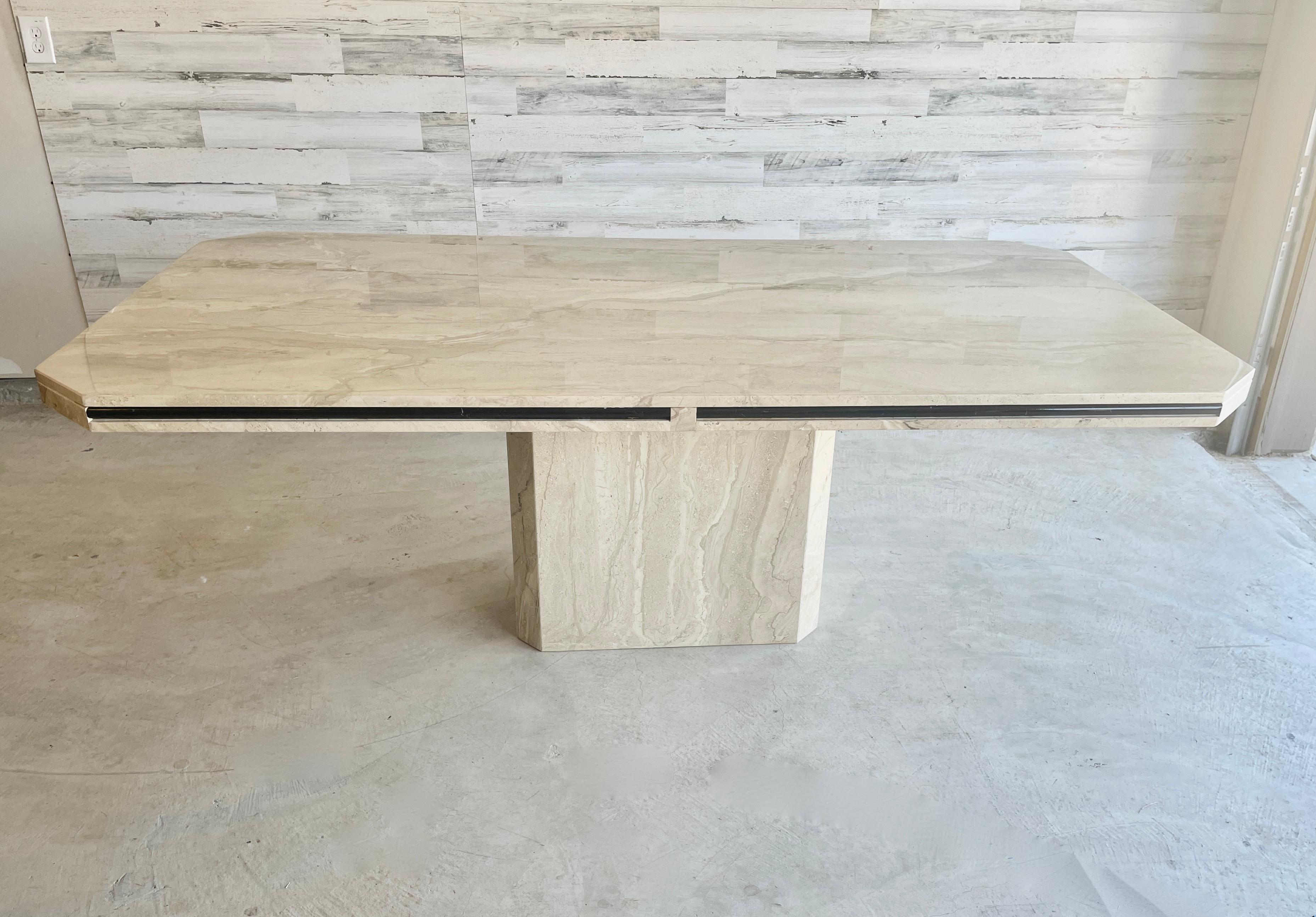 1980s Travertine dining table with black marble trim around the rim. Mixed Tan and cream swirling with hints of light pink.
