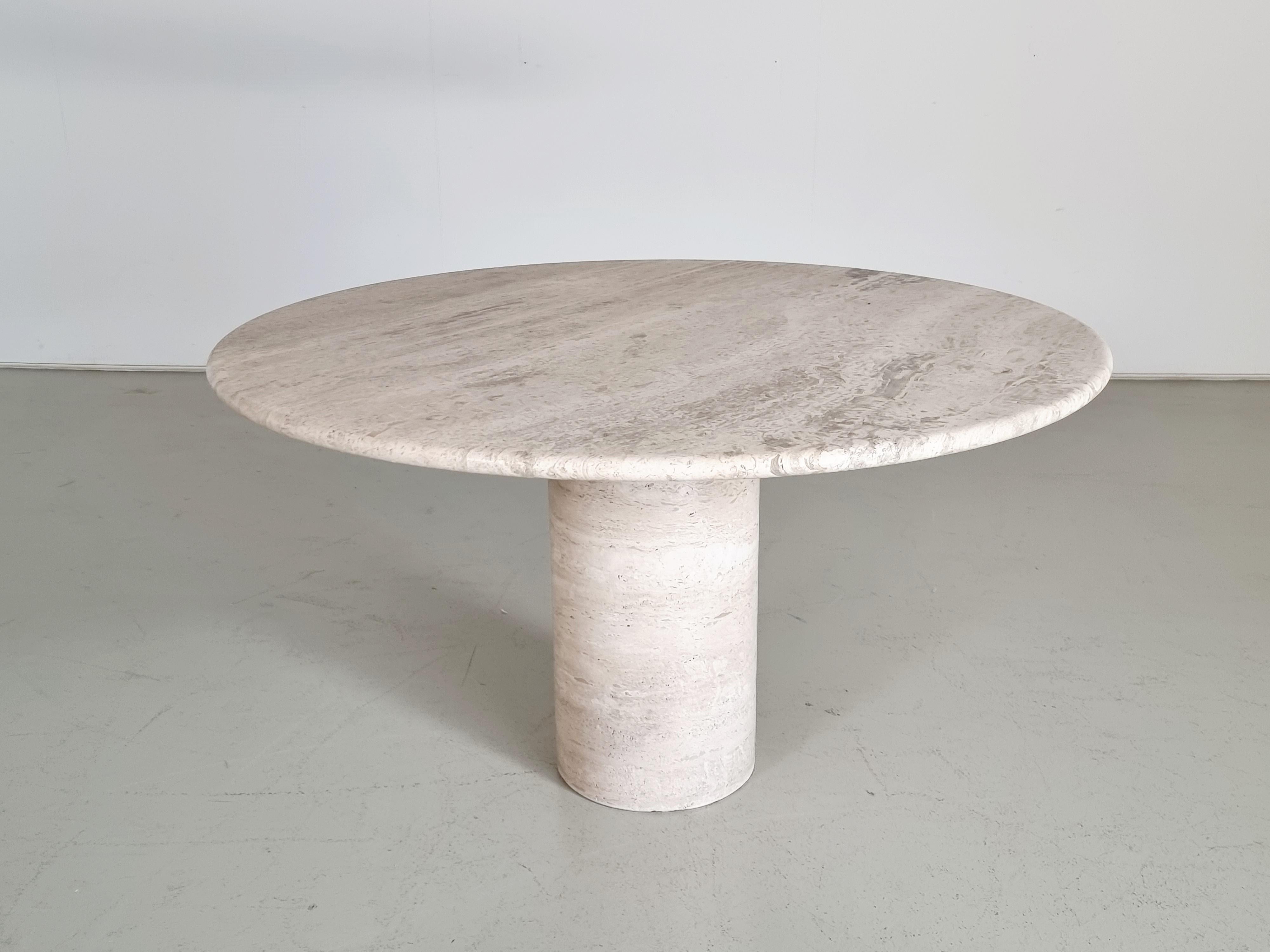 High-quality Italian travertine marble table in very good condition.

Attributed to Up & Up Italy in the 1970s. Thick travertine top in variegated tones of grey, beige, and brown. The top rests on a round pedestal base also made of travertine. The