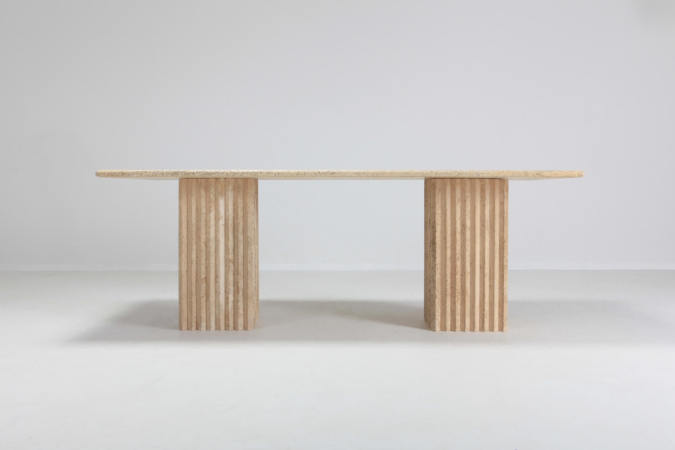 Postmodern piece in travertine marble that can be used as a writing desk or dining table.
Fits 6 to 8 persons.
The two impressive columns are not attached to the table, these can be placed freely underneath the top. You could also turn them 45° so