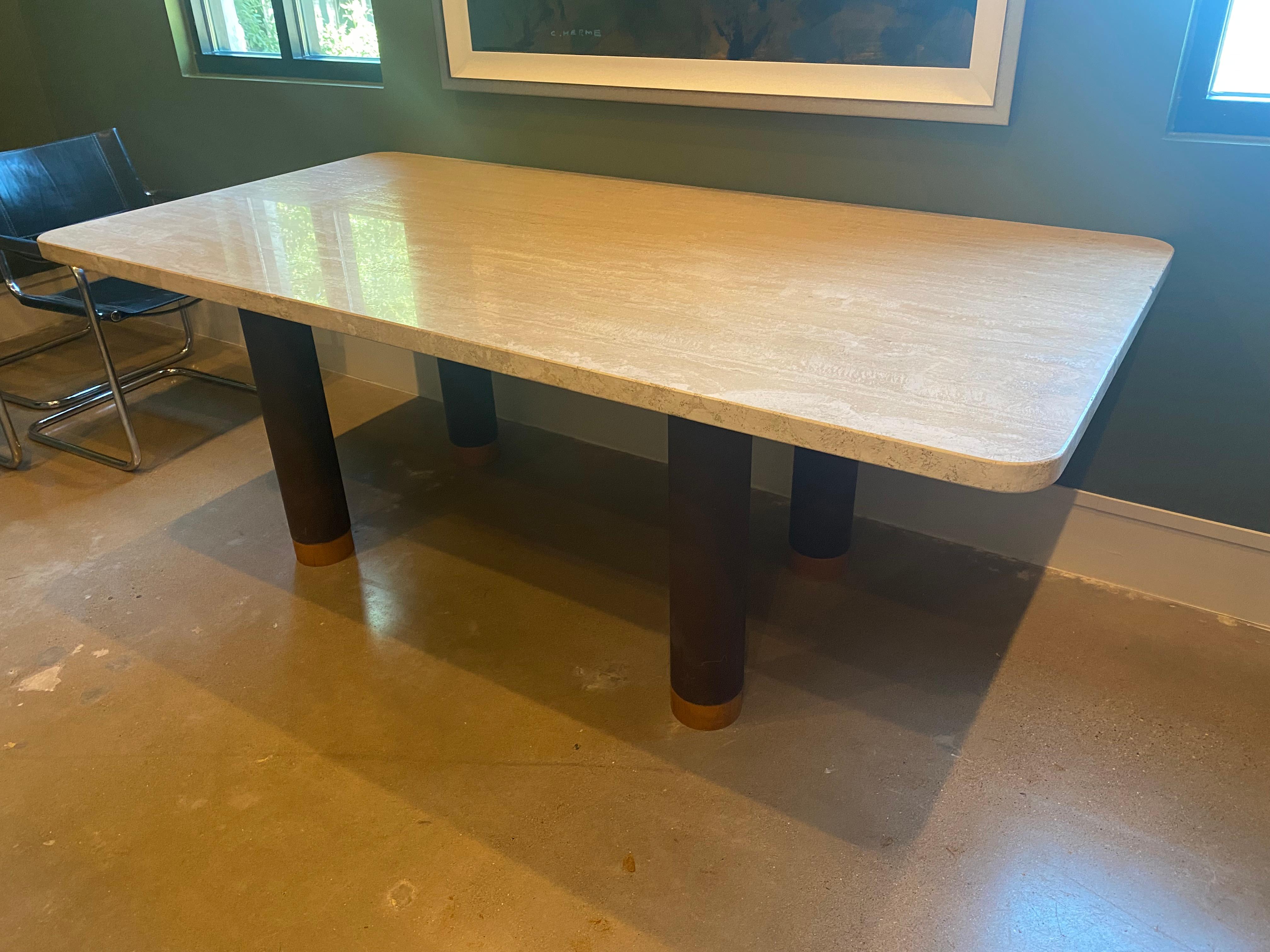 Italian travertine dining table with thick stone top. Tubular steel base in brown has solid wood caps at feet. Stone looks slightly lighter in person than in the photographs. Stone top removes for transport. Italy, 1970's.