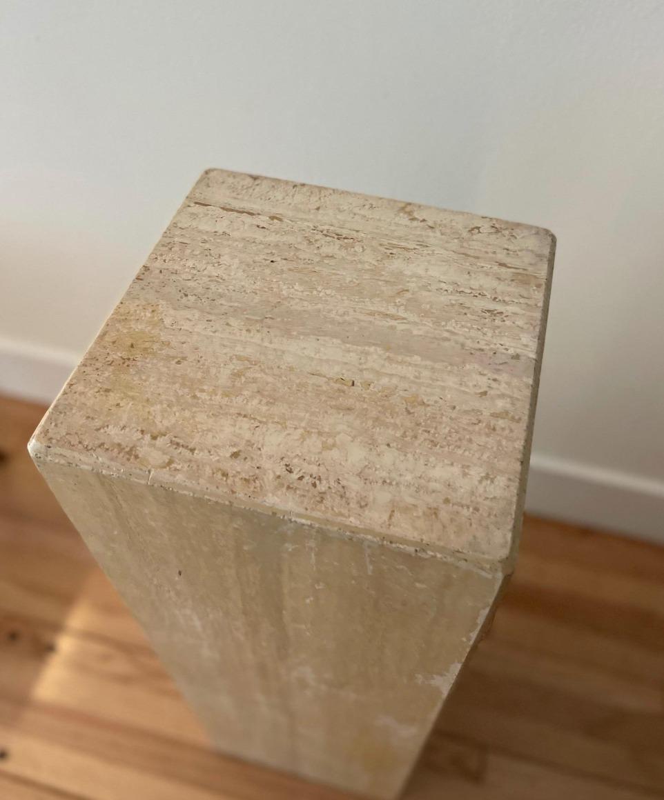 Groovy travertine pedestal to display your fleurs or favorite sculpture.

