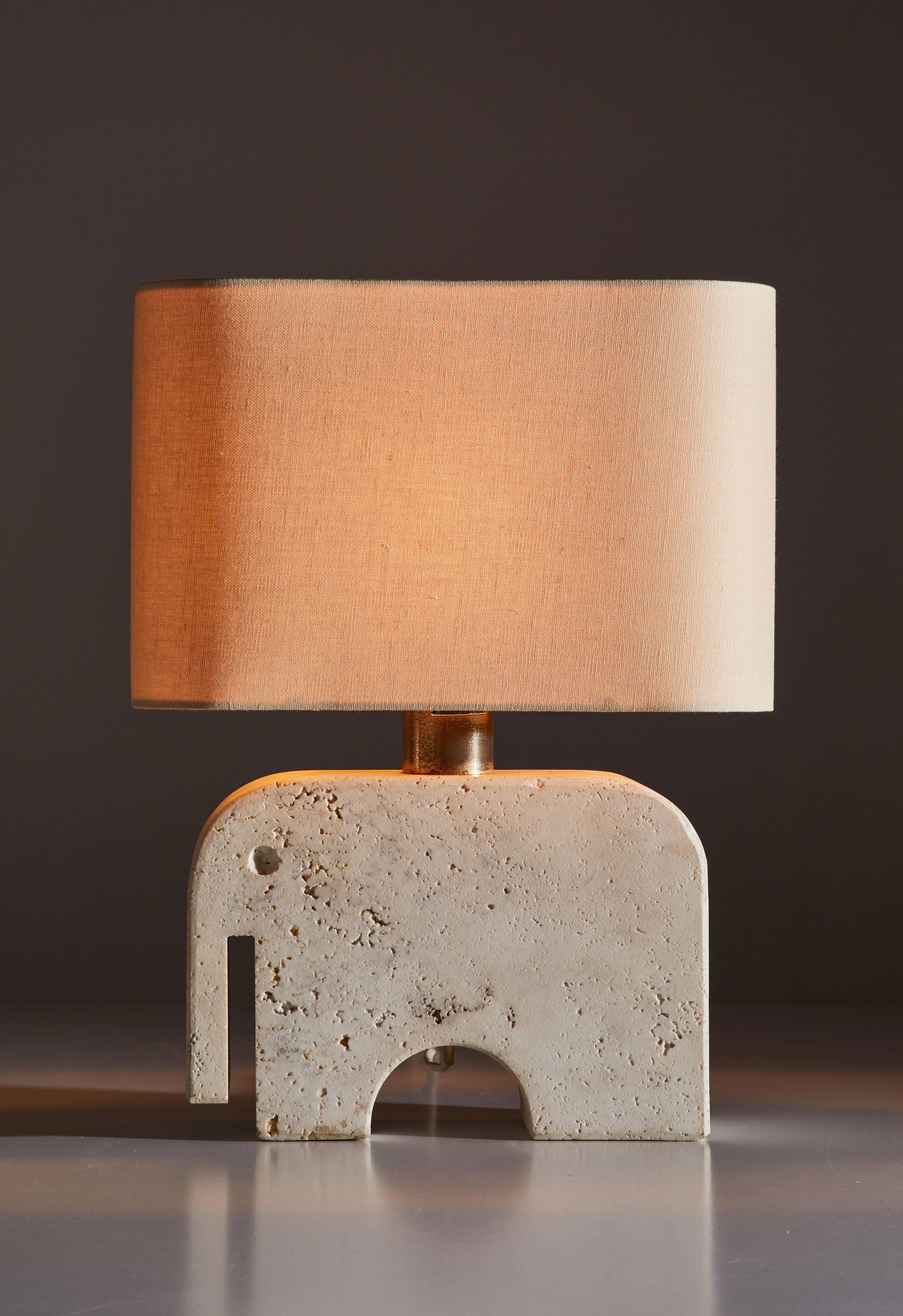 Travertine elephant table lamp manufactured by Fratelli Manelli in Italy, circa 1970s. Chromed brass stem. Original cord. Custom linen shade included. Takes one E27 100w maximum bulb. Retains original manufacturer's label. Height displayed is for