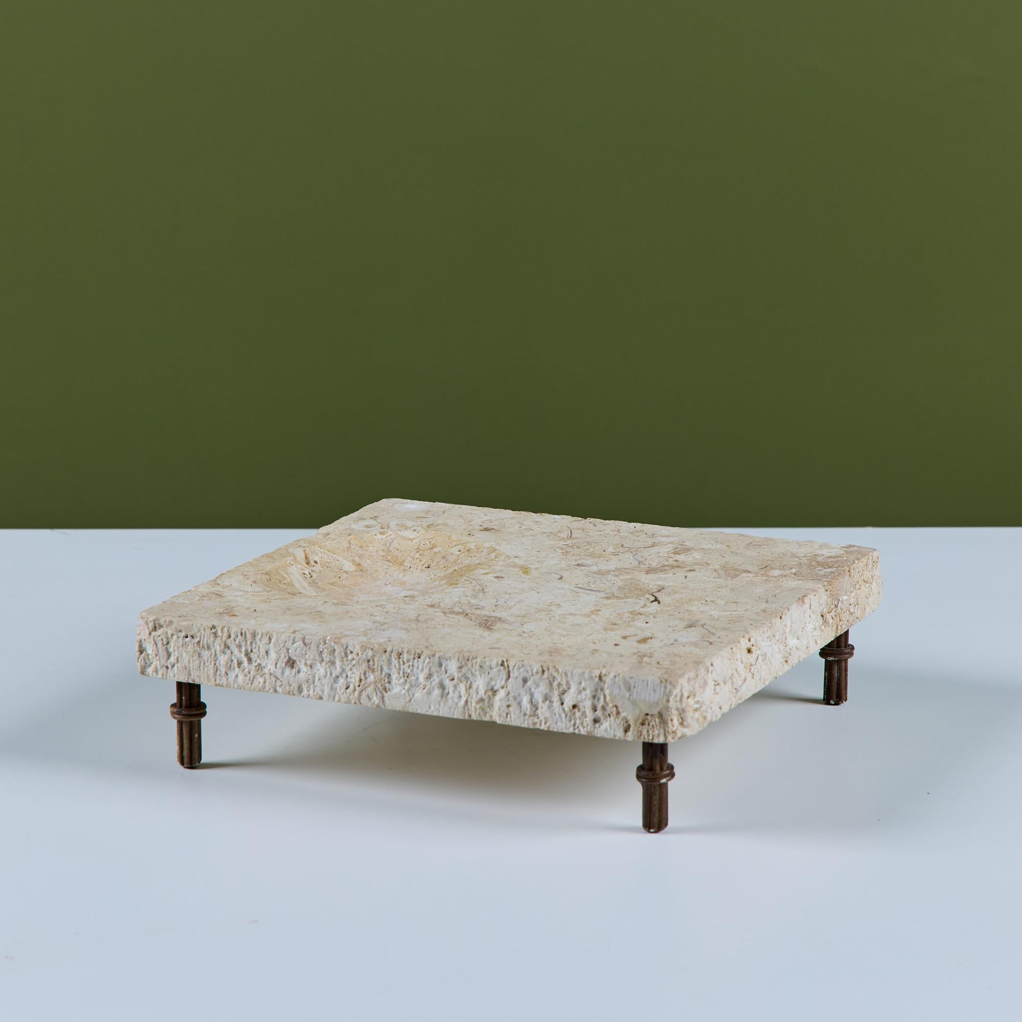 Square travertine catchall with oval divot on one side. The raised dish rests on four metal legs.

Dimensions
9