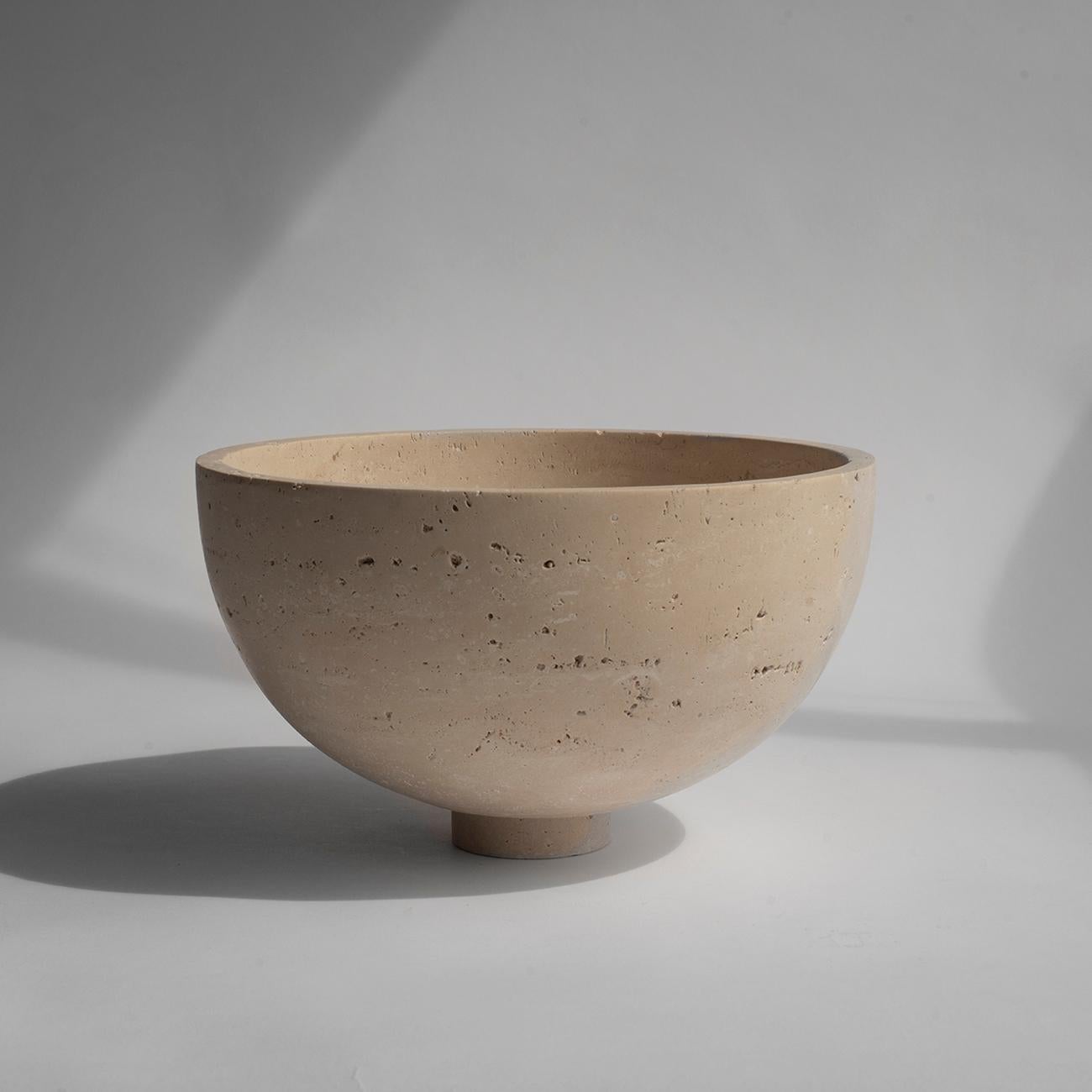 A substantial travertine bowl crafted from a natural travertine stone rests atop a mini pedestal for a grand presentation of fruits. It is truly an eyecatcher in your dining room. 

There may be natural variations that are not product flaws, they