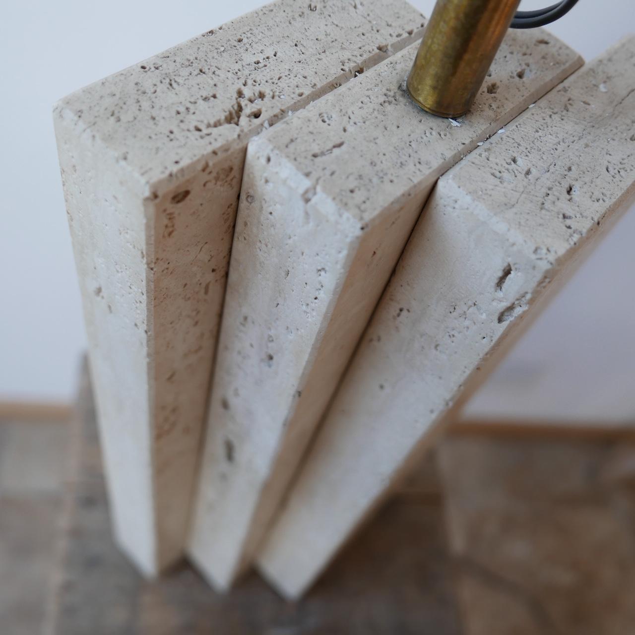 A solid travertine table lamp.

Formed from three sets of travertine slabs which create great lines from every angle.

Belgium, circa 1970s.

Since re-wired and PAT tested.

Dimensions: 56 H x 12 D x 19 W in cm.
