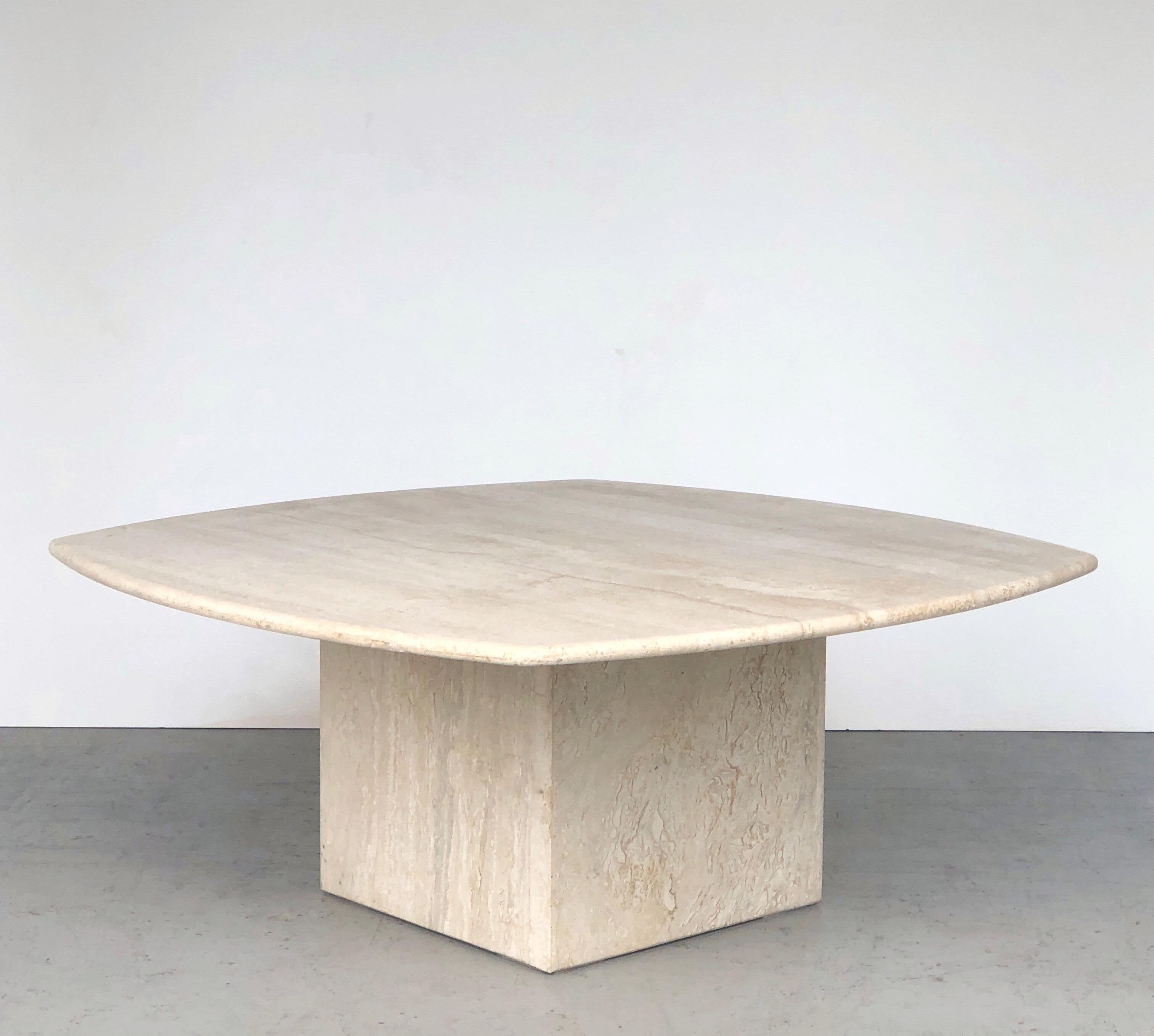 A very serene design on this table. Basically a square solid travertine top with radial sides resting on a cube. Beautiful grain. Stamped 