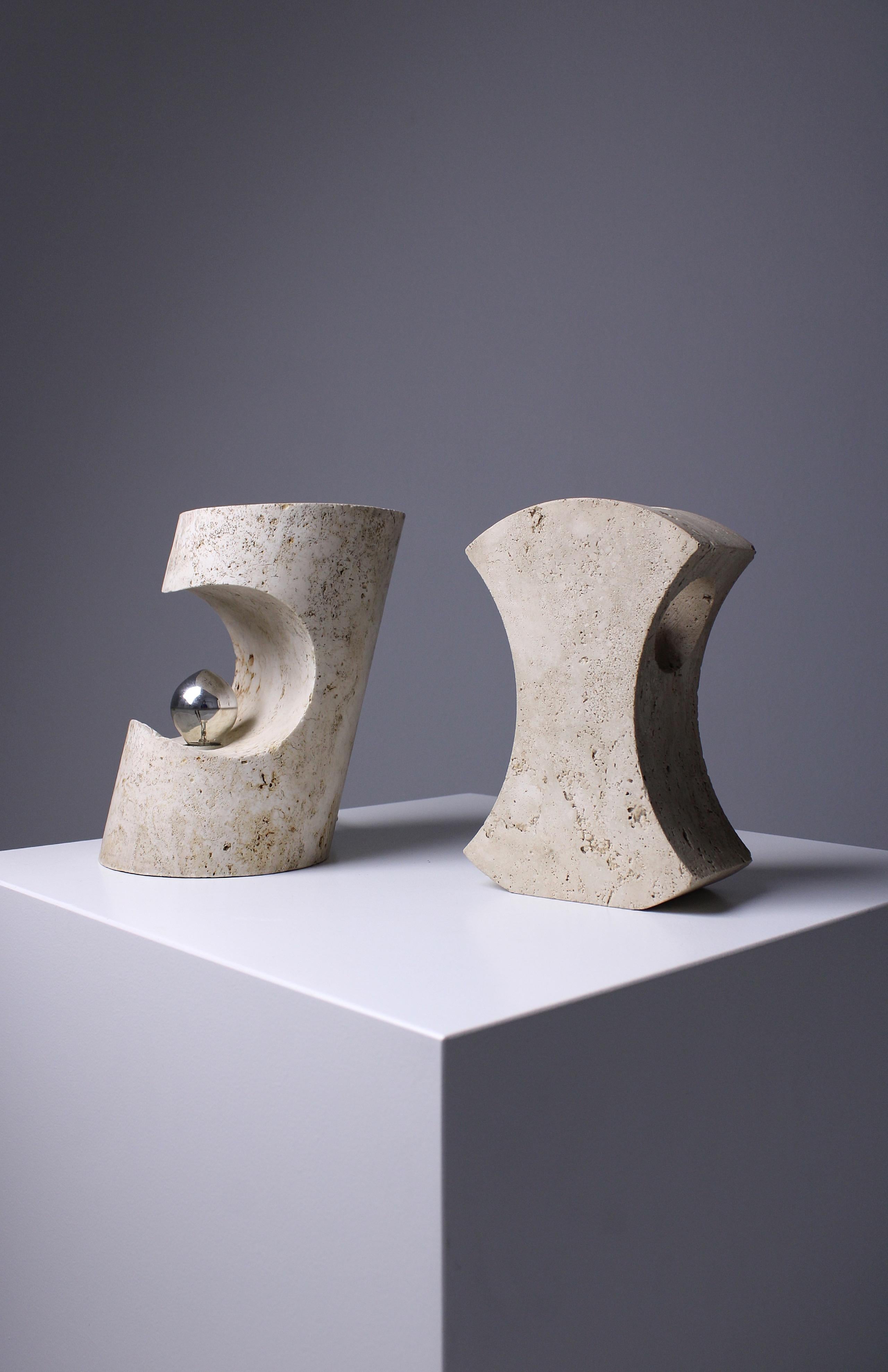 Designed around 1971 by Giuliano Cesari and Enrico Panzeri, these sculptural table lamps were crafted by Nucleo, a division of the Sormani furniture company in Milan, Italy. Both are made entirely from a single piece of unfilled travertine, the