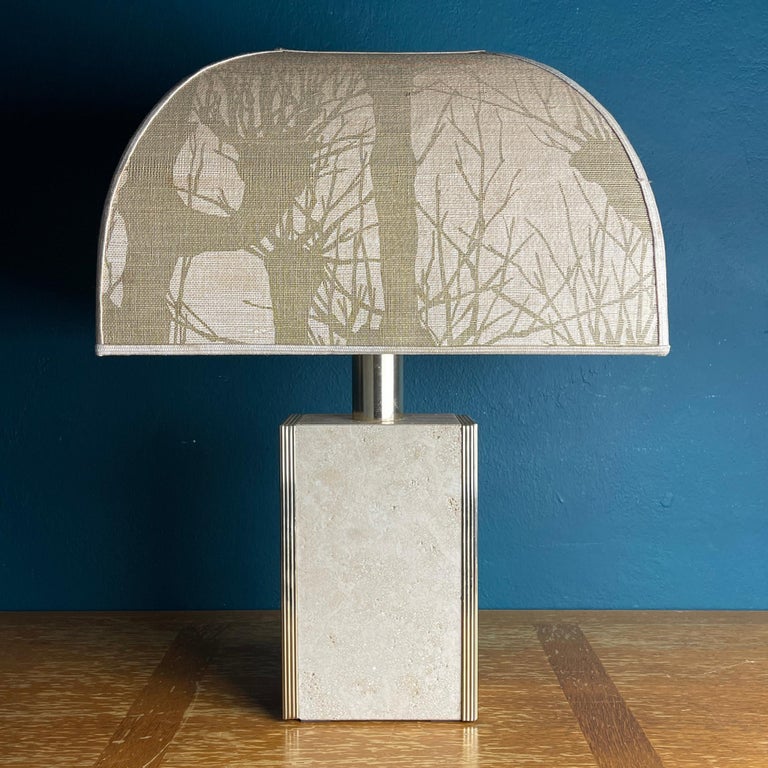 The architectural vintage Italian travertine marble lamp with brass edge, made in the 1970s. The rectangular base is made of travertine with brass details. Travertine is a form of limestone and can be found in several places in Europe. Very good