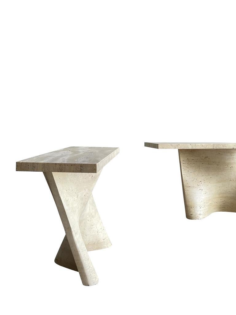 A pair of exceptional 1970s Italian travertine consoles of dramatic sculptural form. The consoles have unique, deep soft curves.
Both the tops and bases are made from unfilled Italian travertine with a honed finish.
Arriving August.