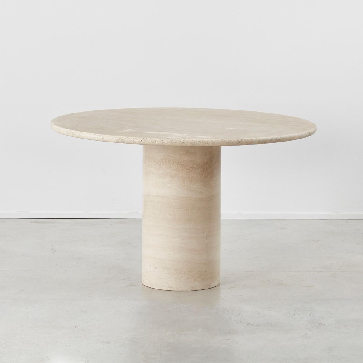 This minimal dining table is cut from travertine stone and presents a form not too dissimilar to one by Angelo Mangiarotti for Up&Up. Travertine is a form of limestone that exhibits pleasing natural colour variations, its holey surface adding