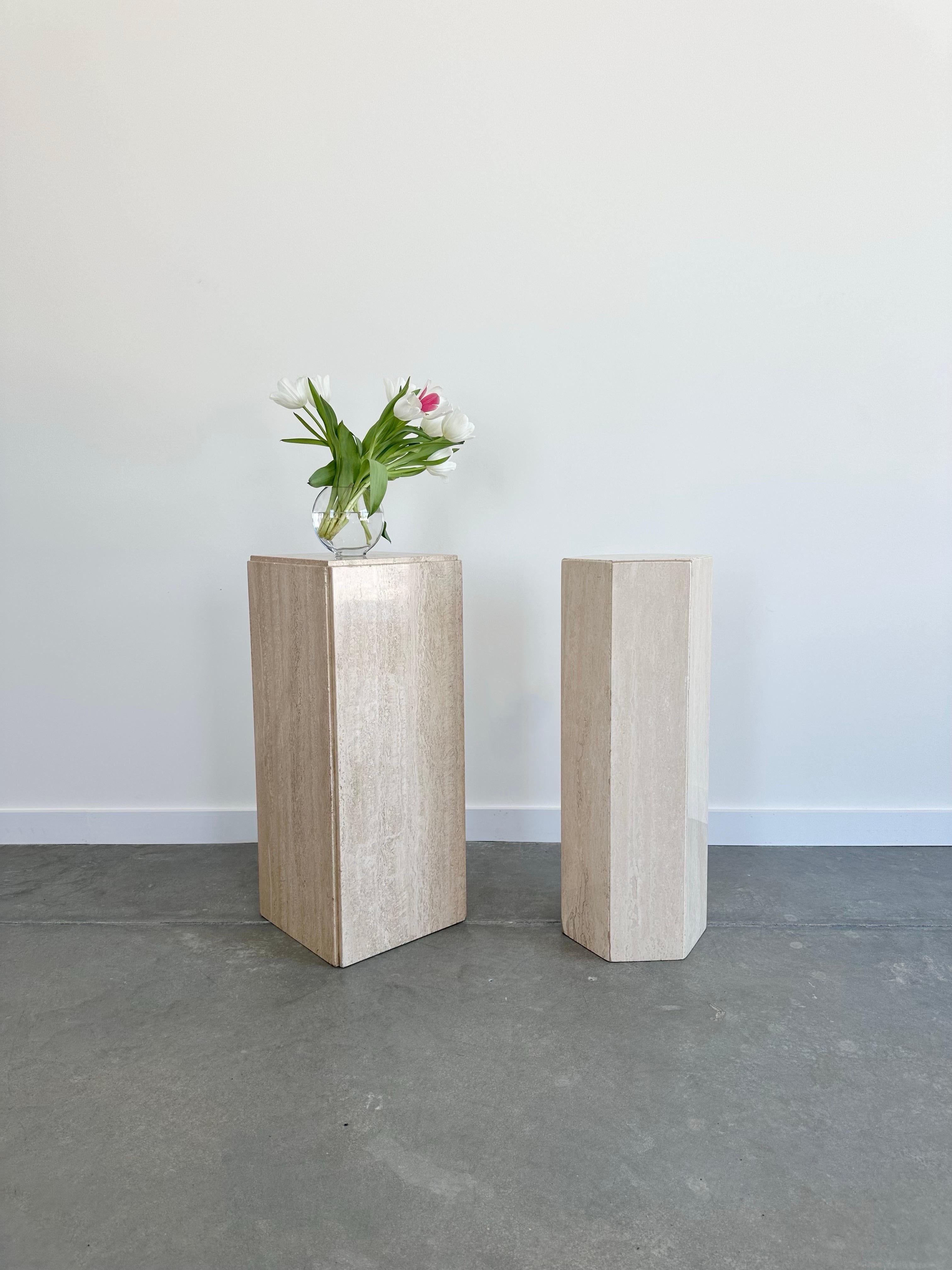 A clean and simple vintage buttercream travertine pedestal, with a lovely matte honed finish and chamfered edges. This elegant and timeless piece of furniture is crafted from solid and sturdy travertine, offering a warm and natural touch to any