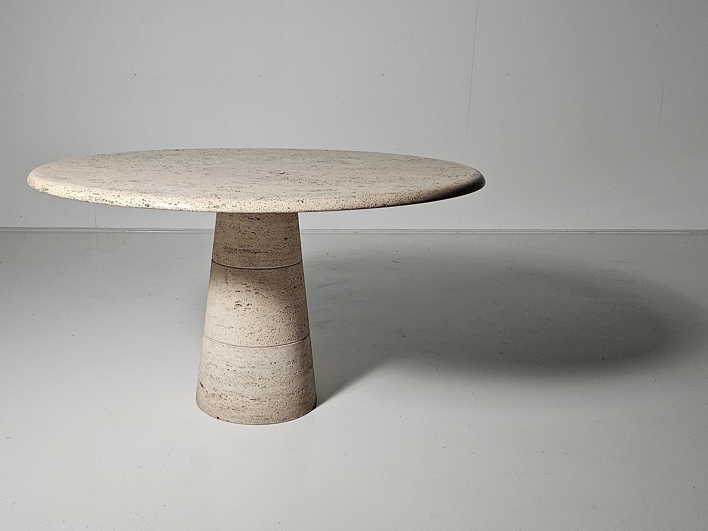 High-quality Italian round travertine marble table by Up & Up Italy.

Thick travertine top in variegated tones of grey, beige, and brown. The top rests on a round pedestal base also made of travertine. The top balances perfectly and securely on the